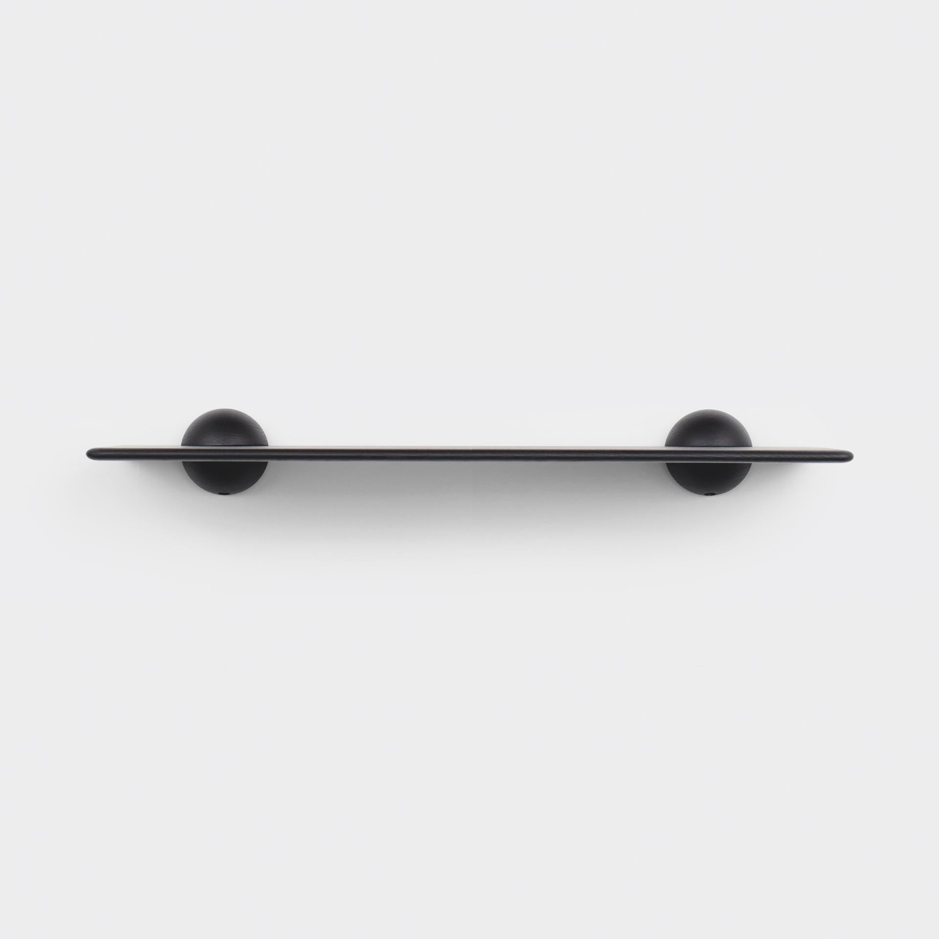 The half sphere holding the plane contributes to a bold yet minimal look that works well in several different spaces and environments. Whether used as a shelf or as a bar table it is present with its distinct form without taking over. Combining the