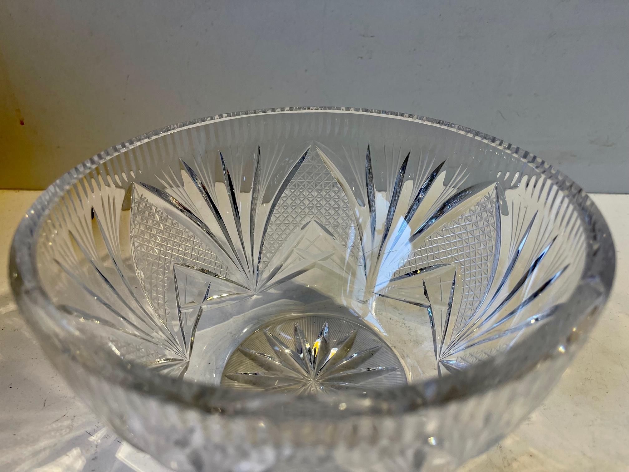 An intricately cut and engraved lead crystal bowl. Decorated with floral impressions. Made in Scandinavia probably by Orrefors circa 1930-40. Measurements: D: 18, H: 9.5 cm.