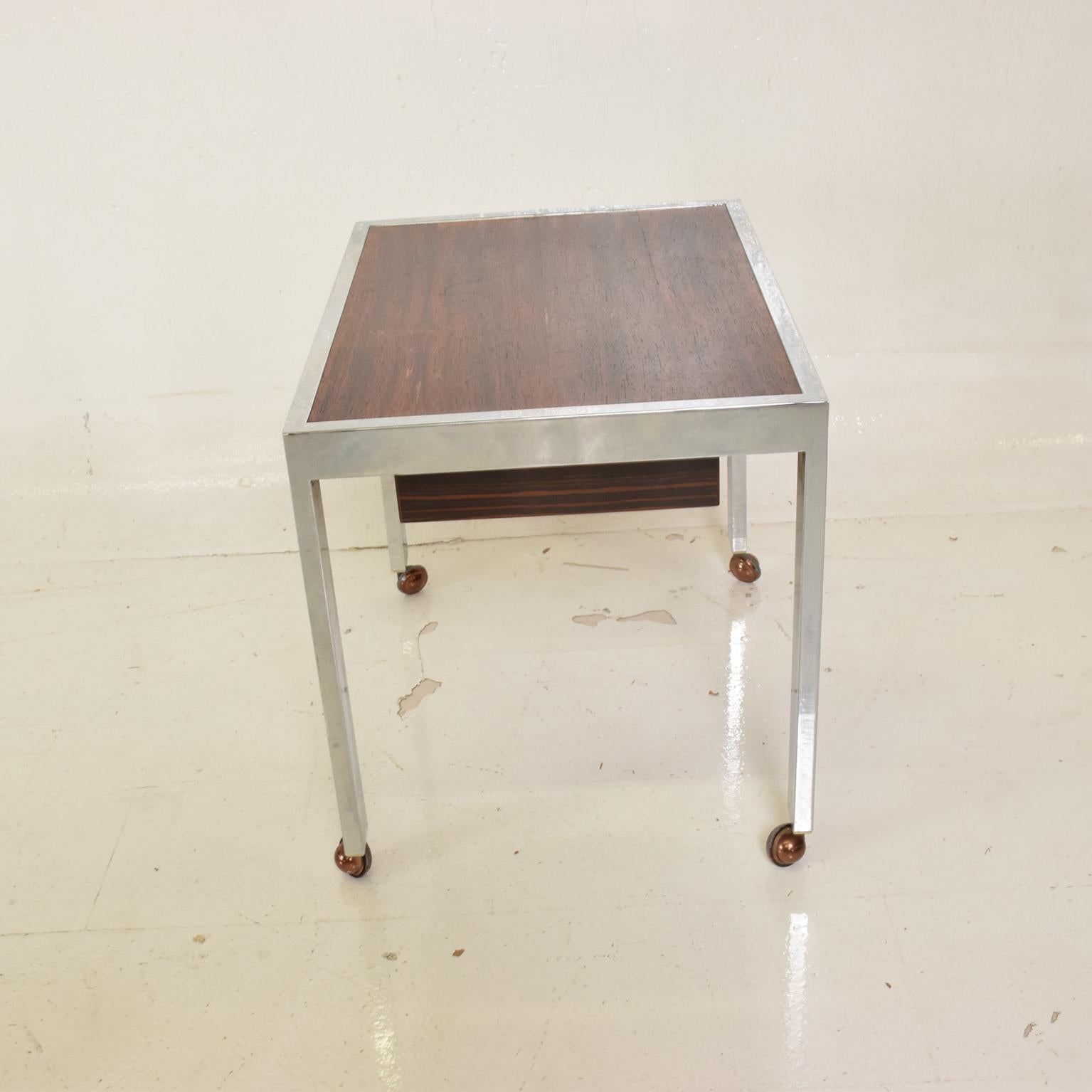 For your consideration, a Scandinavian Danish modern side table in rosewood and chrome.

Unmarked. Very good vintage condition. Refer to images. 

Denmark, circa 1960s.

Dimensions: 20