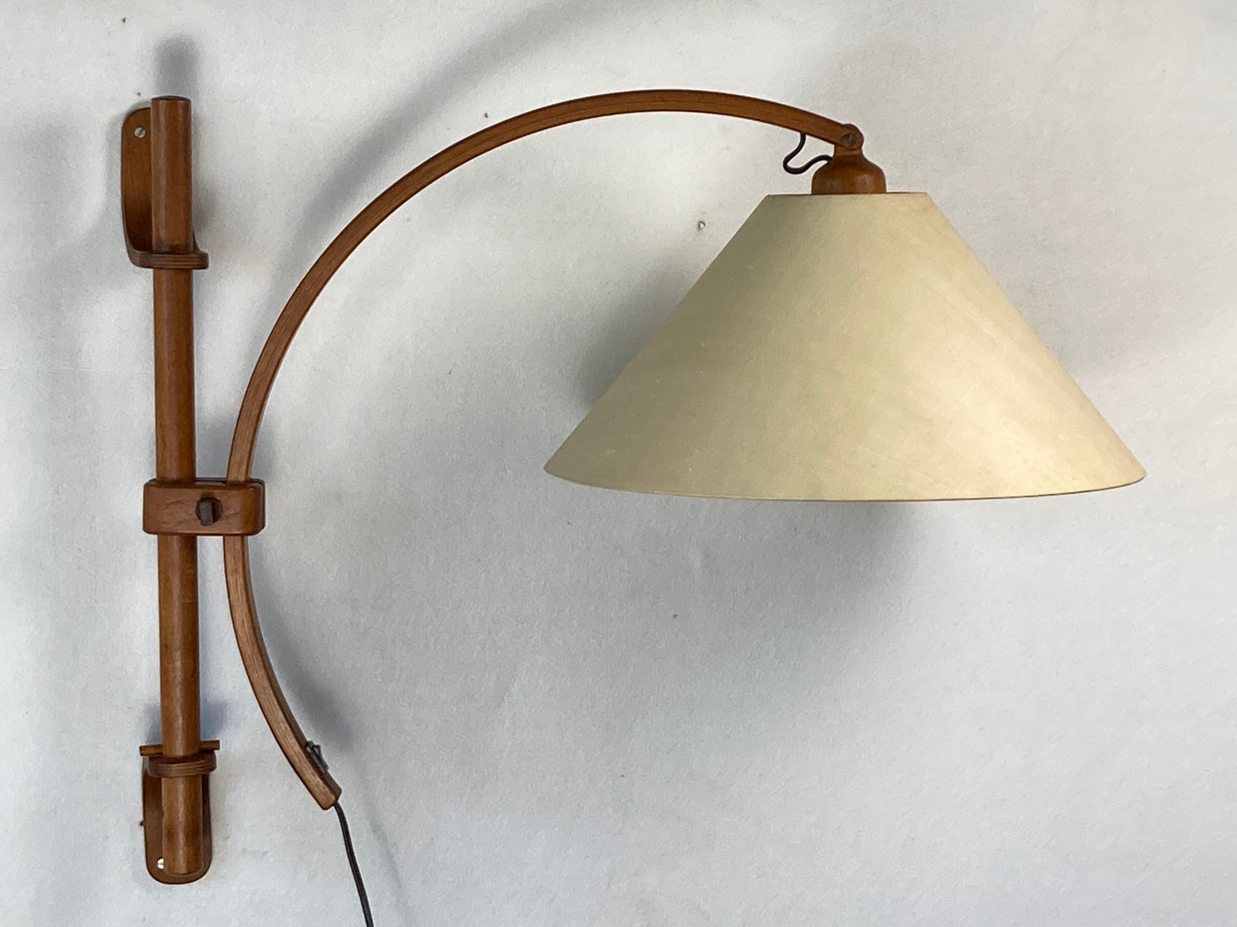 Wonderful Scandinavian Danish oak wall arc swing lamp, 1970s either by Domus or very much in its style. This adjustable swing lamp is in great condition with no real flaws to mention. The shade is without any dents, tears or anything, it only only