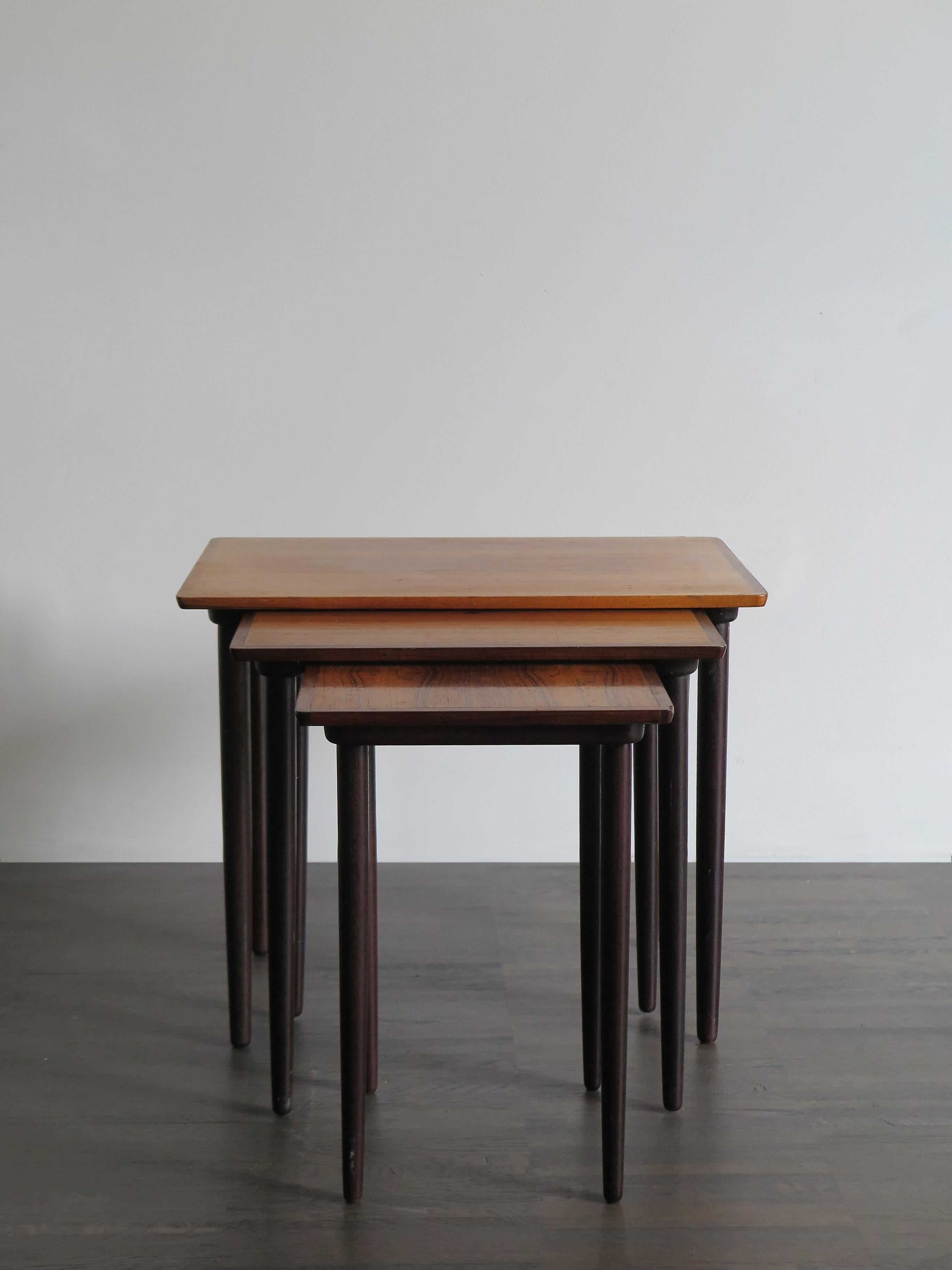 Danish nesting tables set in veneer dark wood, circa 1960, midcentury design.

Please note that the item is original of the period and this shows normal signs of age and use.