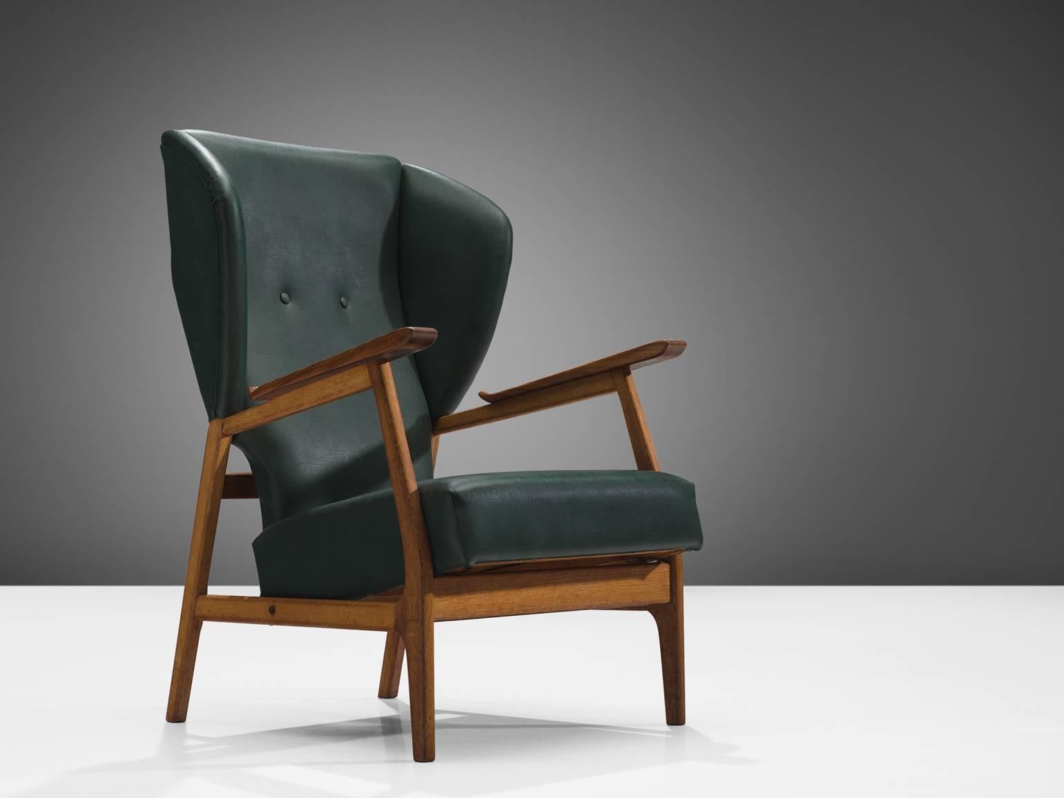 Lounge chair, in teak and green faux-leather, Scandinavia, 1960s.

This wingback armchair features the style of Aksel Bender Madsen. This chair has a teak frame, which has a nice open character. The wingback is wide en emphasizes the comfortable