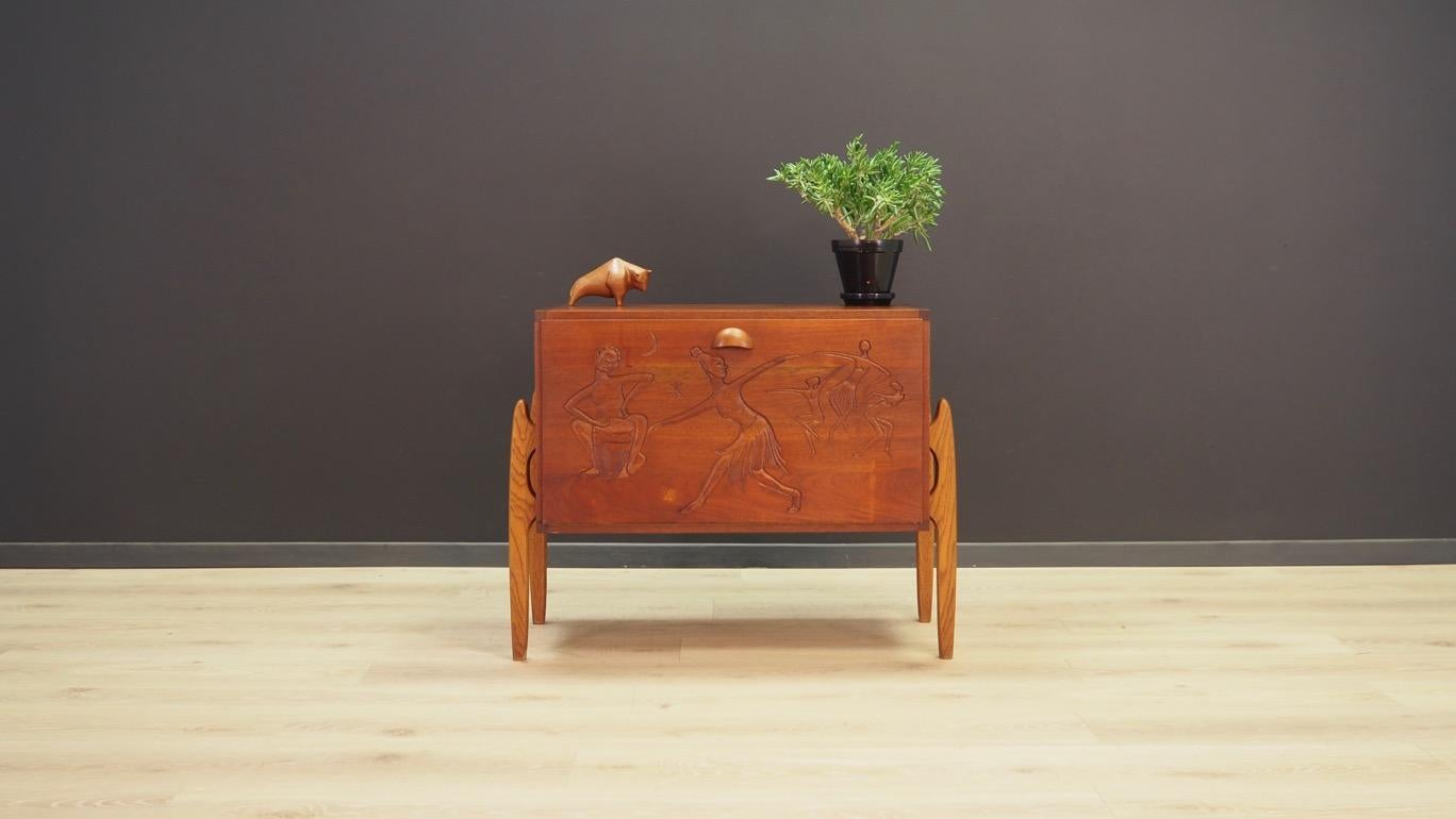 Remarkable cabinet from the 1960s-1970s, Minimalist form - Scandinavian design. Roomy interior behind the door. The whole is veneered with teak. An additional advantage is handmade sculpting and unconventional legs. Preserved in good condition