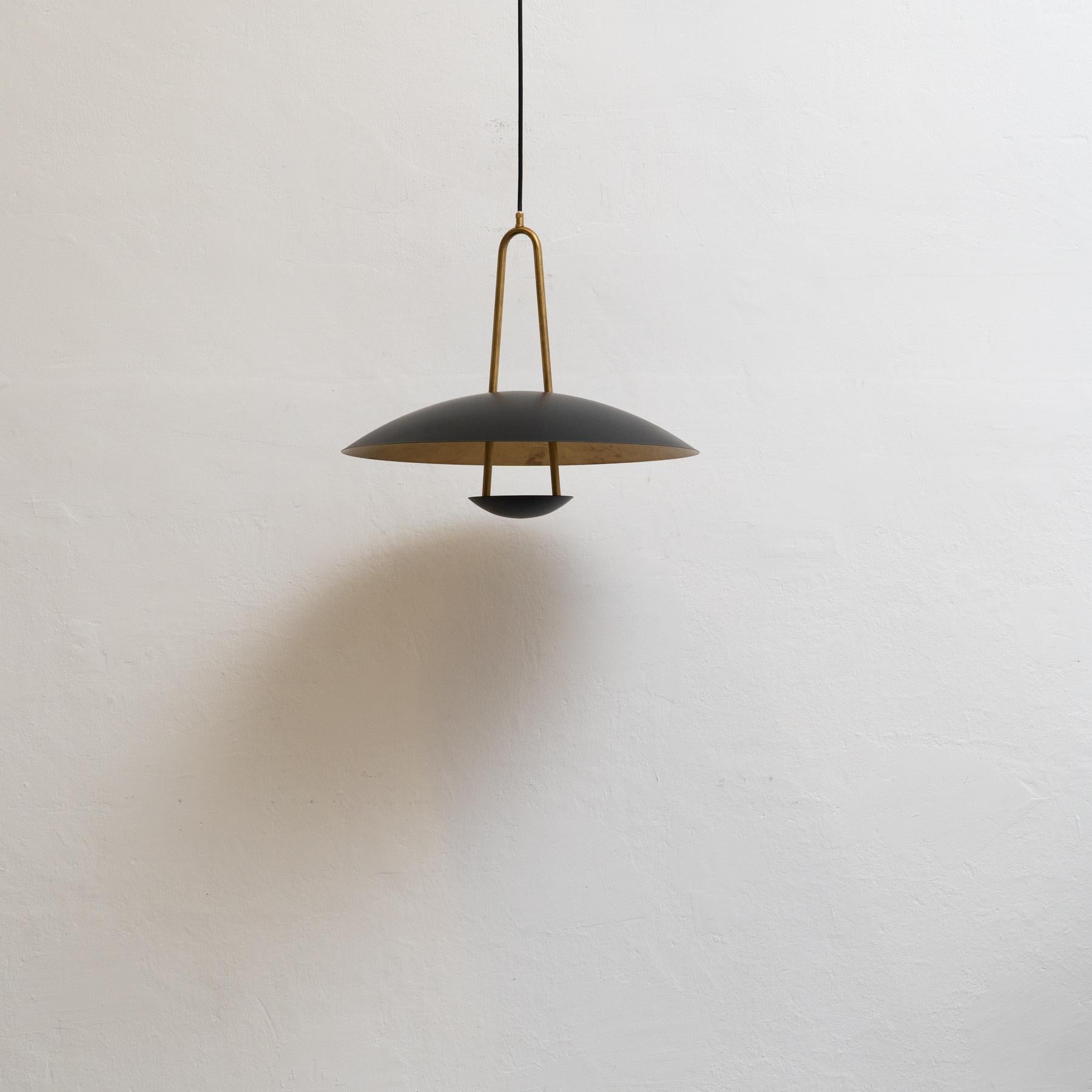 Add a touch of Scandinavian elegance to your home with this stunning ceiling lamp by Konsthantverk. Designed by Johan Carpner, the Satellit 55 model features a sleek black mat and raw brass finish. Crafted using traditional techniques, this lamp is