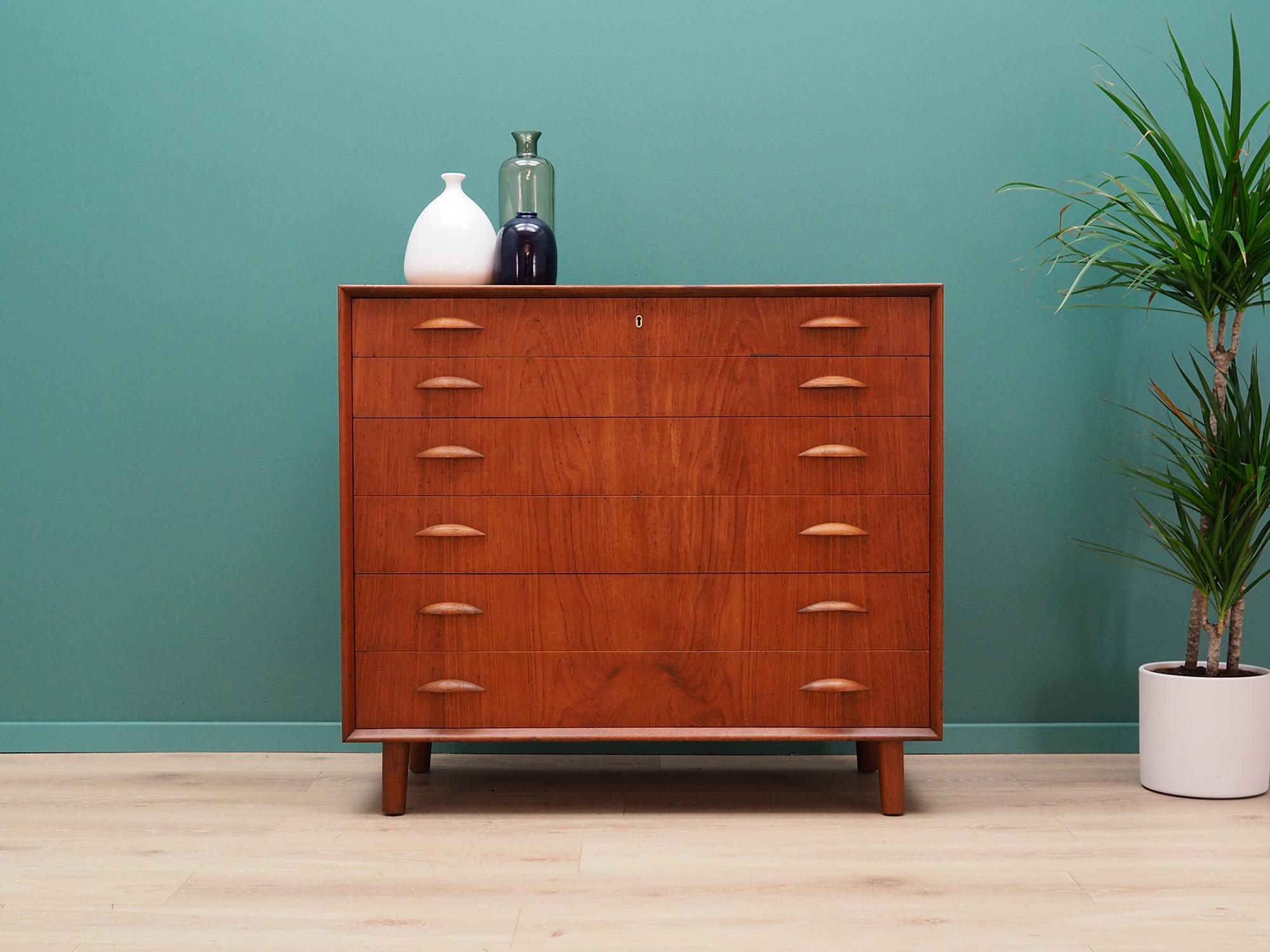 Phenomenal chest of drawers from the 1960s-1970s. Scandinavian design, Minimalist form. The surface of the furniture finished with teak veneer. The chest has six packed drawers. No key in the set. Preserved in good condition (small bruises and