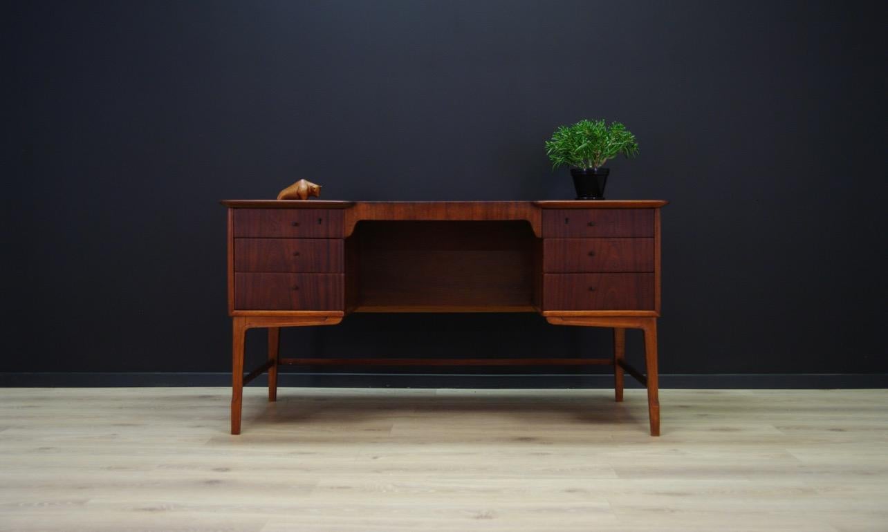 Classical desk from the 1960s with Minimalist Scandinavian design. Desk veneered with mahogany. On the front six drawers, on the back a bookshelf and a roomy space behind the sliding door. No key in the set. Preserved in good condition (small