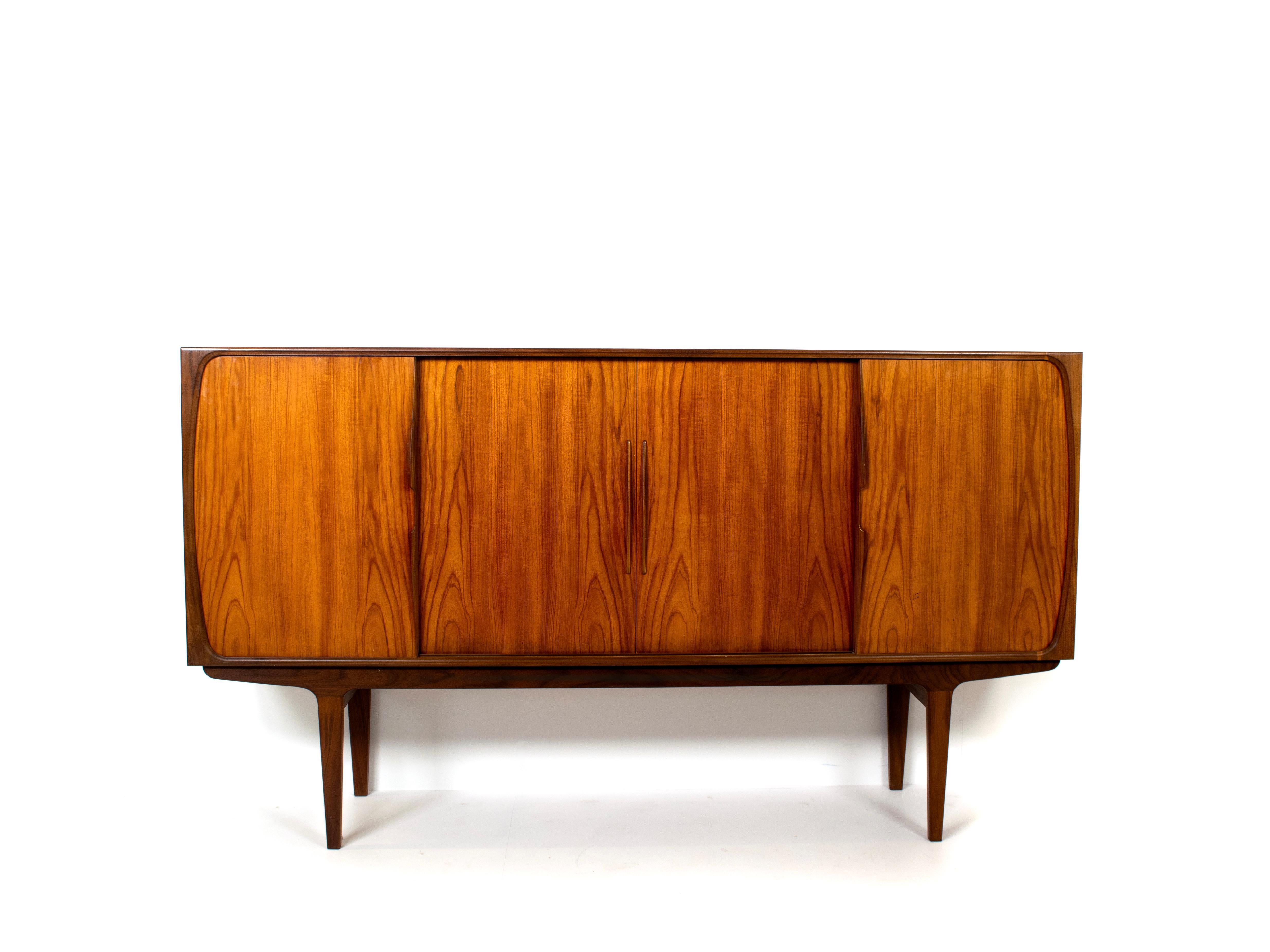 Amazing Scandinavian design sideboard in teak from the 1960s. Although not marked, this sideboard could very well be designed by Omann Jun from Denmark. This sideboard has four sliding doors. One on each side with two shelves behind them and two in