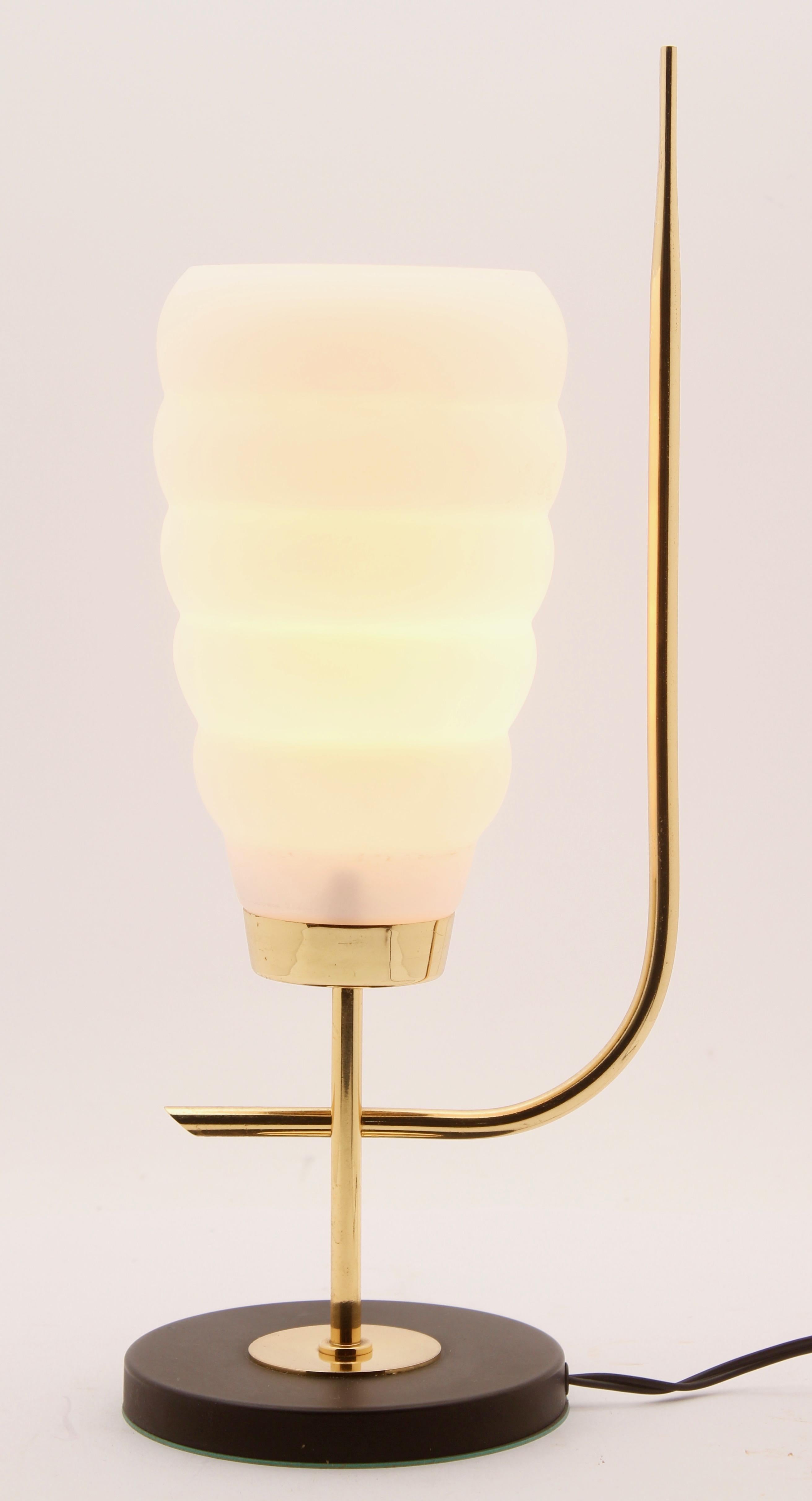 1970s table lamp in the Scandinavian style with brass fittings on a metal base. The lamp has a shade made of acid-etched milk-glass giving it a matte, white surface, and provides a strong up-light with a softer, diffused light at eye level.
Ideal