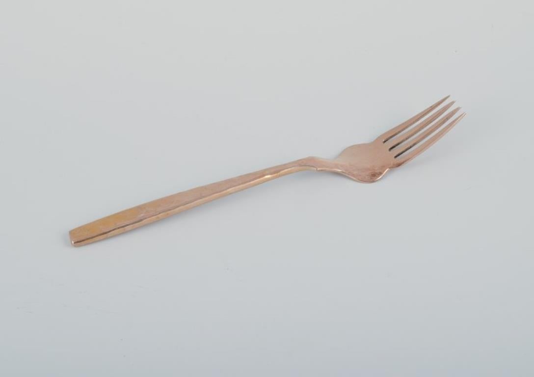 Scandinavian Modern Scandinavian designer. Complete twelve-person fish service in hammered brass. For Sale