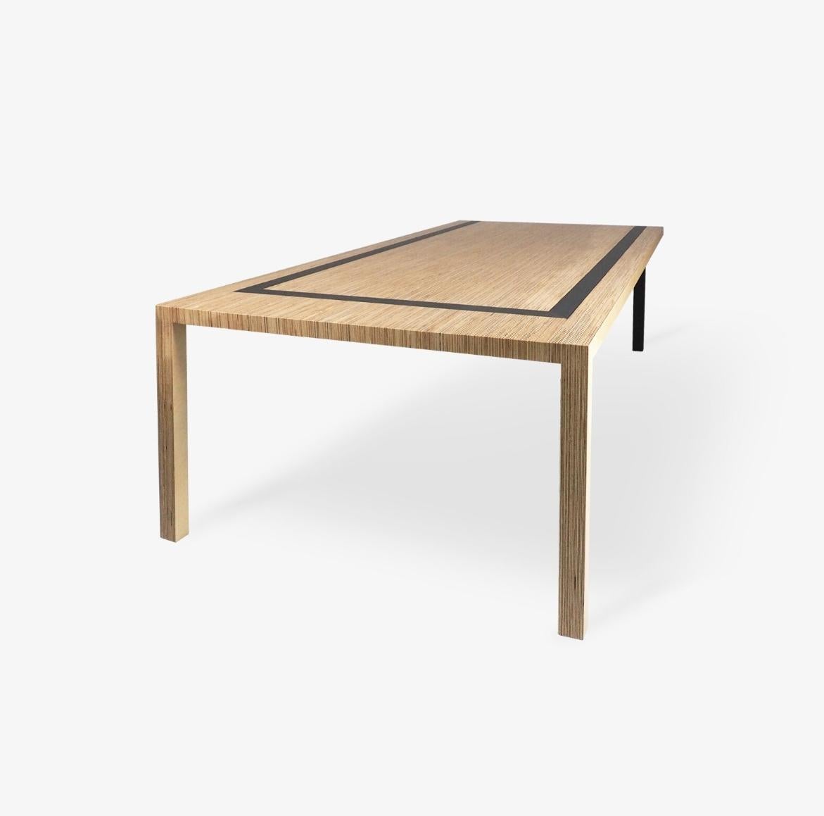 A “U” shape holds this table together forming a dynamic and asymmetrical piece. Each pair of legs is different, giving the table a different look on each side.

It’s minimalistic elegance contrasts with strength.
This table also conceals extensive