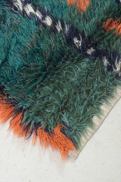 Scandinavian designer. Rya carpet in shades of green, blue, orange, and white.