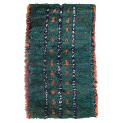 Scandinavian designer. Rya carpet in shades of green, blue, orange, and white.