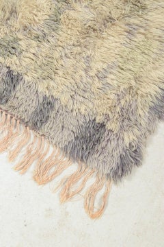 Scandinavian designer. Rya carpet in wool in shades of grey, beige, and lilac.