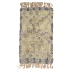 Scandinavian designer. Rya carpet in wool in shades of grey, beige, and lilac.