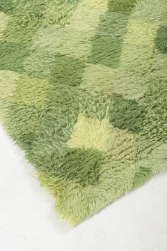 Scandinavian designer. Rya carpet with checkered pattern in shades of green.