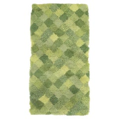 Scandinavian designer. Rya carpet with checkered pattern in shades of green.