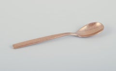 Scandinavian designer. Set of eleven coffee spoons in hammered brass.