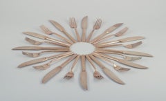 Scandinavian designer. Twelve-person dinner service in hammered brass.
