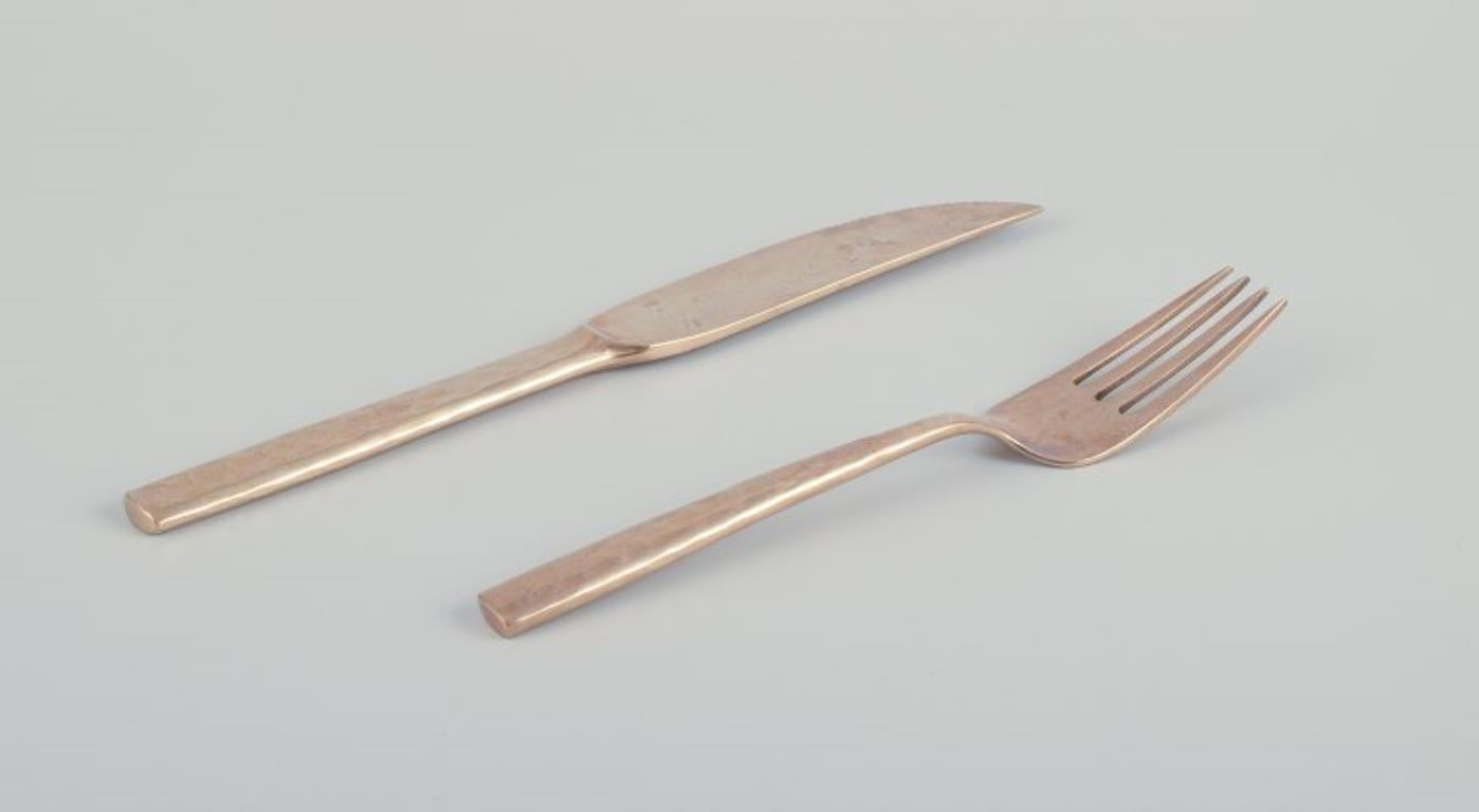 Scandinavian Modern Scandinavian designer. Twelve-person dinner service in hammered brass. For Sale