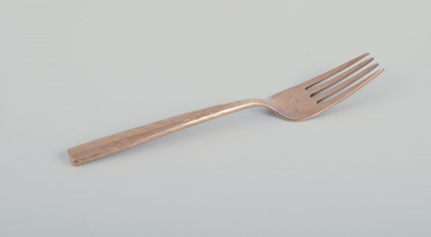 Hammered Scandinavian designer. Twelve-person dinner service in hammered brass. For Sale