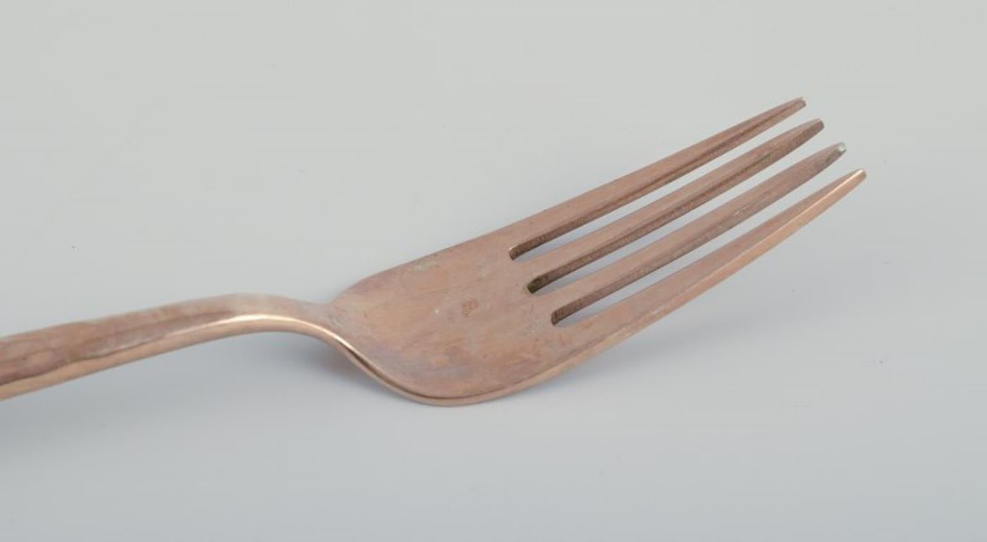 Late 20th Century Scandinavian designer. Twelve-person dinner service in hammered brass. For Sale