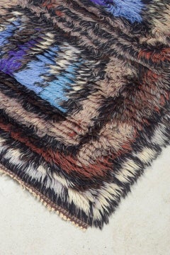 Scandinavian designer. Wool Rya carpet in shades of blue, purple, brown, beige.