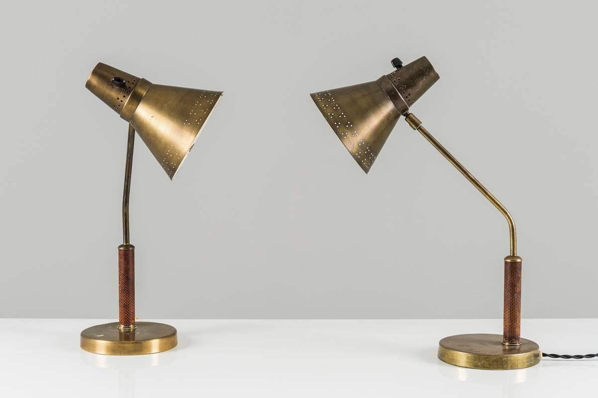 Beautiful desk lamps by Swedish manufacturer AB E. Hansson & Co., circa 1940. The shade is made of brass with a perforated edge, giving a beautiful light. The shade sits on a brass stem and is adjustable in any direction. The brass stem ends with a