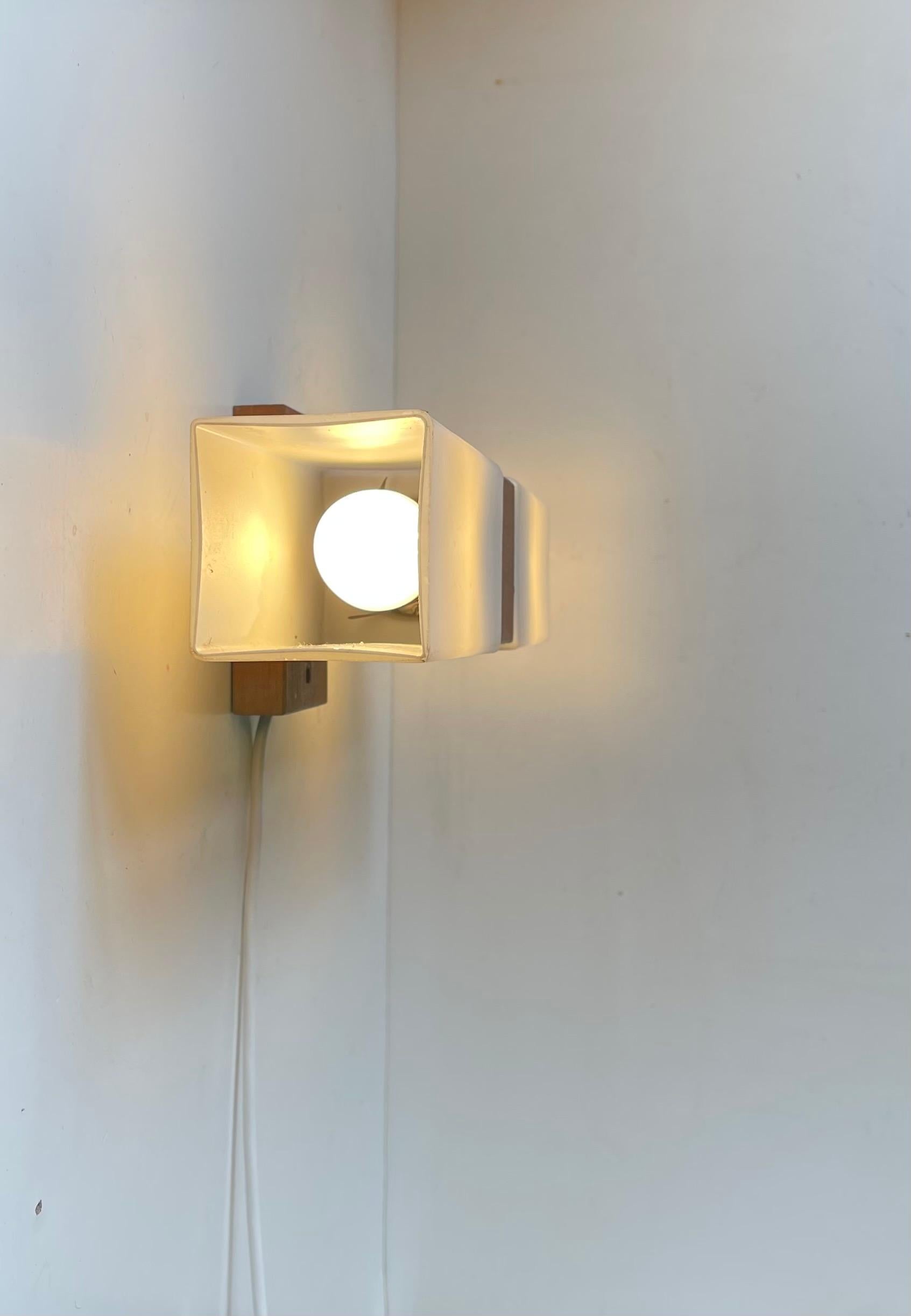 Rectangular double-shaded wall light fashioned from solid teak and white frosted opaline glass. Probably made by either Luxus in Sweden or Lyfa in Denmark circa 1960-65. Suitable for Vanity areas, on top of a mirror or as a center bed-light.