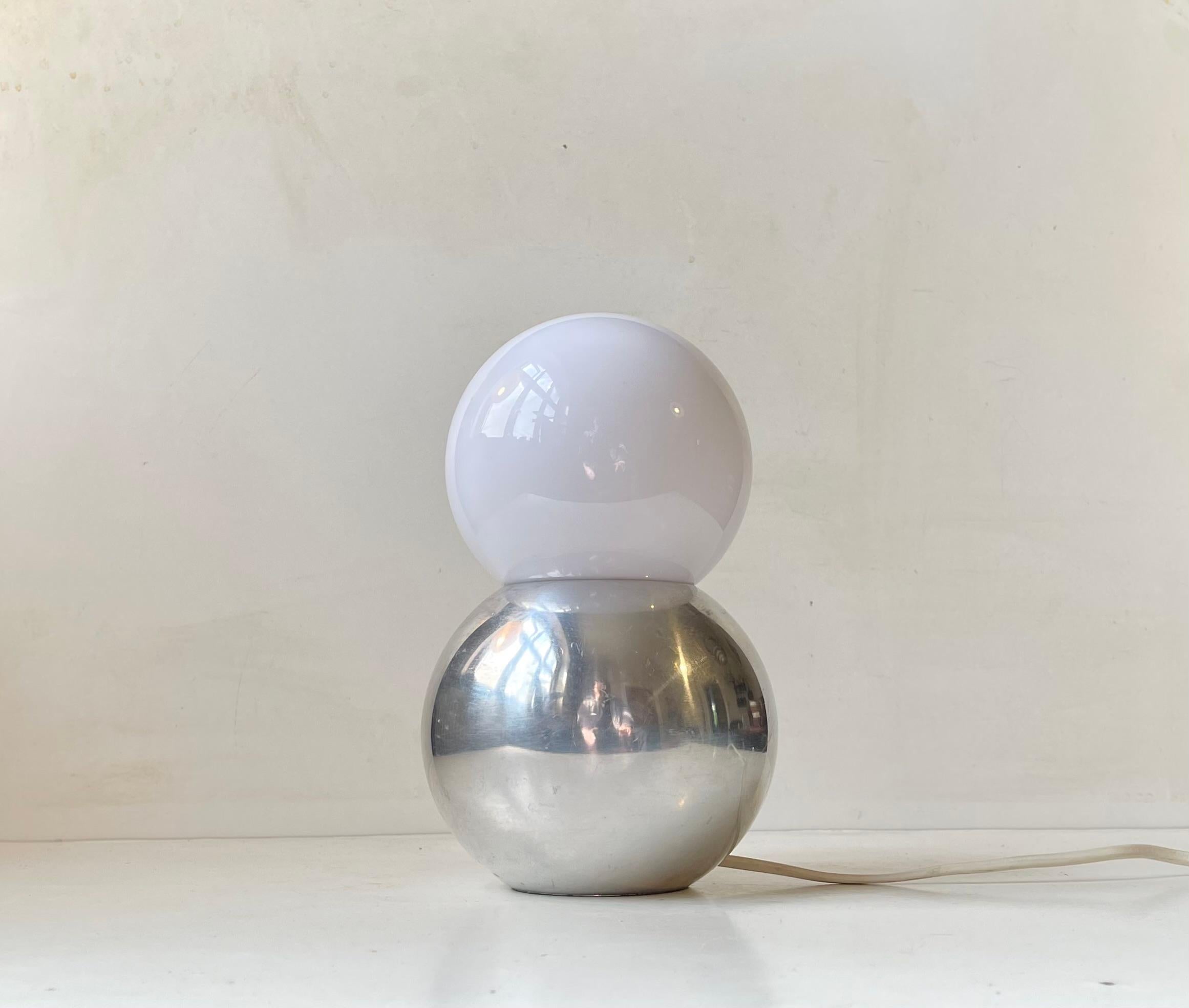 Unusual and Sculptural modern table light executed in polished Aluminum and featuring an acrylic shade. A sphere on a sphere. The perfect mix of Minimalism and Scandinavian organic modern in both shape and composition. Its by an unknown Scandinavian