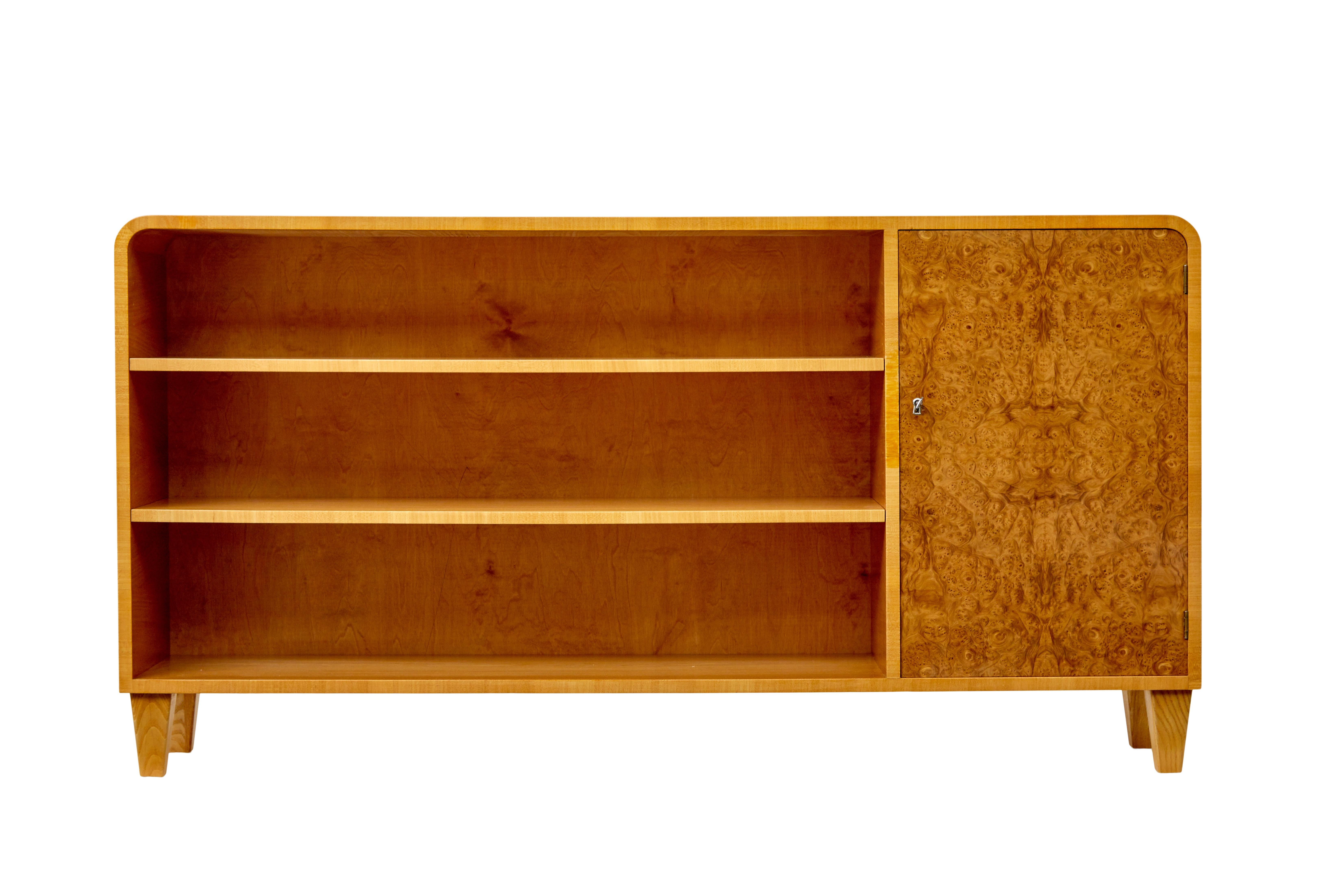Scandinavian elm and burr low open bookcase circa 1950.

Stunning art deco influenced swedish low open bookcase.  Made from elm, narrow depth and rounded ends make this the ideal storage solution for smaller spaces.  Single burr elm quarter veneered