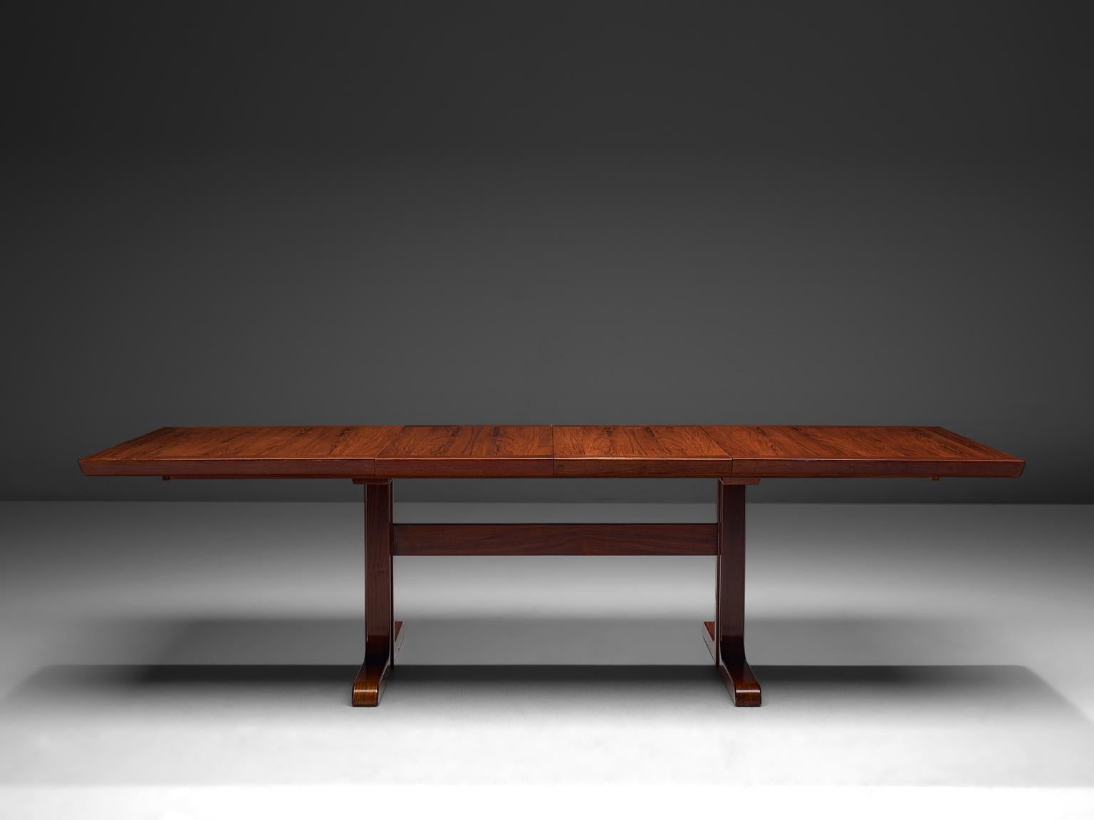 Dining table, rosewood and stained wood, Scandinavia, 1960s

Large rectangular dining table with two additional leafs. The rosewood has a wonderful dark brown-ruby color and shows a beautiful grain on the tabletop. The frame and feet are made of