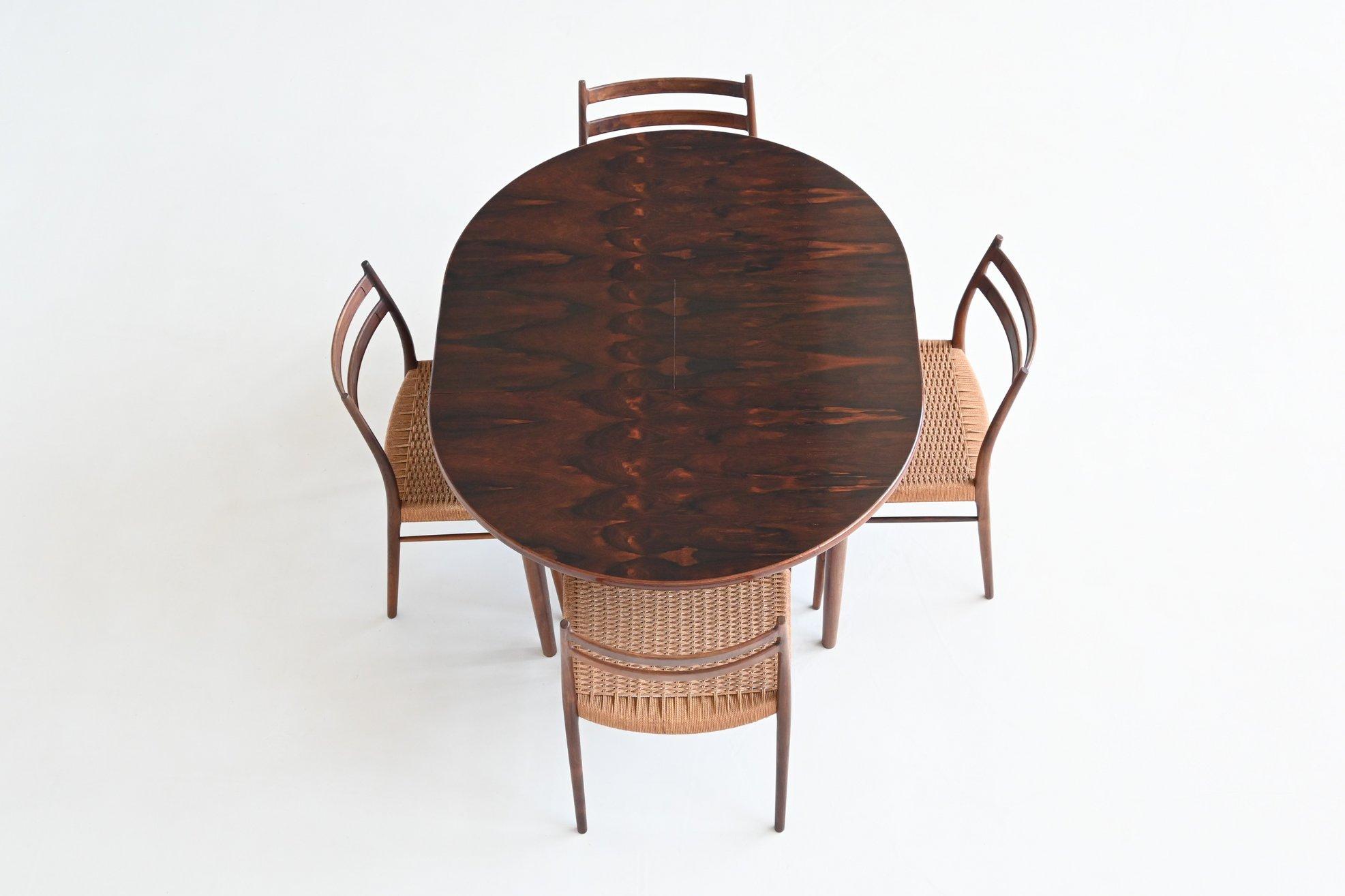 Beautiful oval shaped hardwood extendable dining table by unknown designer or manufacturer, Denmark 1960. This well-crafted table is made of amazingly grained and warm hardwood. The tapered legs are made of solid hardwood and could be dismantled