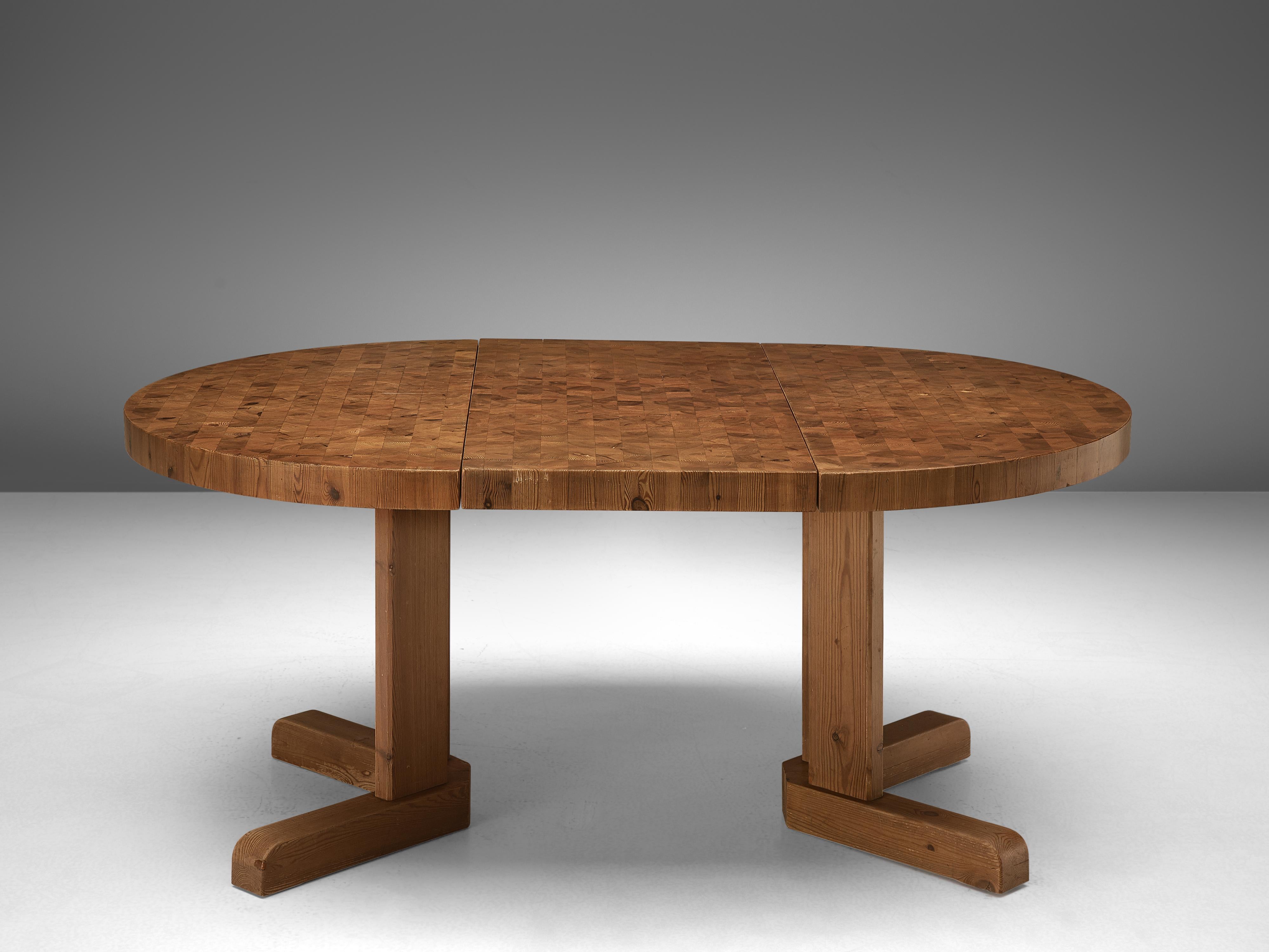 Round dining table, solid pinewood, Denmark, 1960s.

This Scandinavian Modern table features a top executed with pine end-grain wood, which shows a natural pattern. The sturdy tabletop can be extended with an additional leaf, to form an oval top