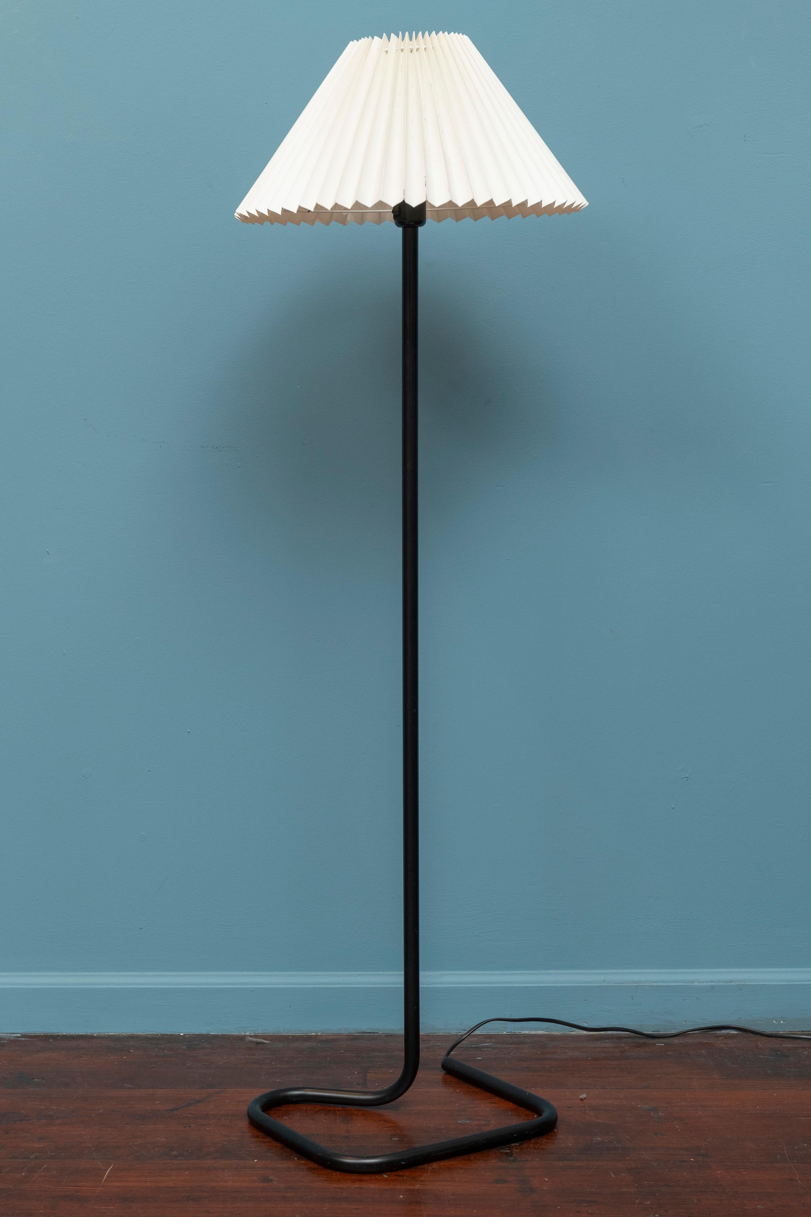 Scandinavian Modern floor lamp, circa 1970's. Eye catching design made from black enameled tubular steel with a vintage pleated shade. In very good vintage condition with a couple crinkles to the shade but in very good presentable condition. New