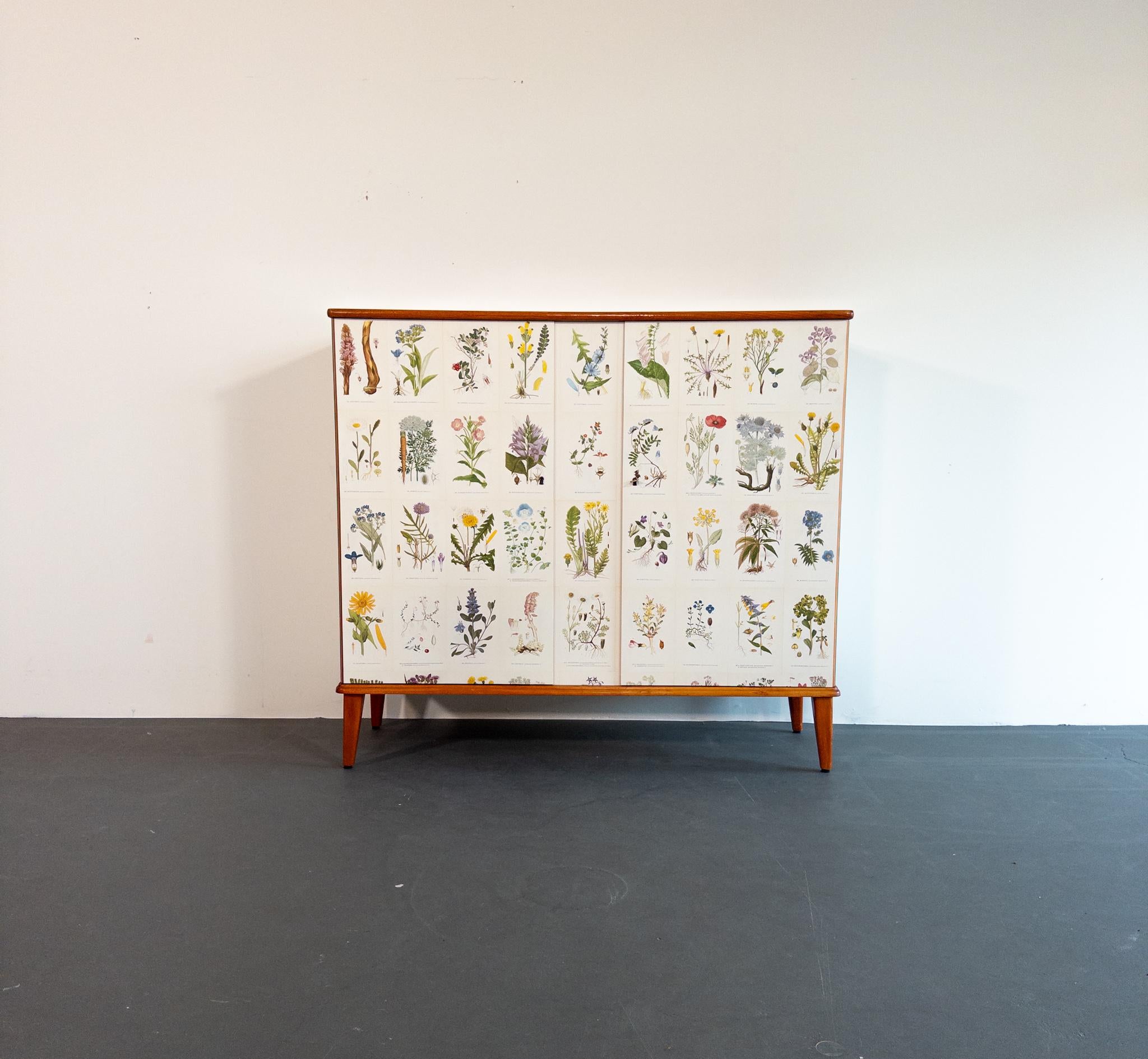 A rare and eye-catching Scandinavian cabinet from the 1940s, crafted in rich mahogany and beautifully inspired by Josef Frank’s iconic Flora cabinet. This piece exemplifies the spirit of Scandinavian modern design, where clean architectural lines