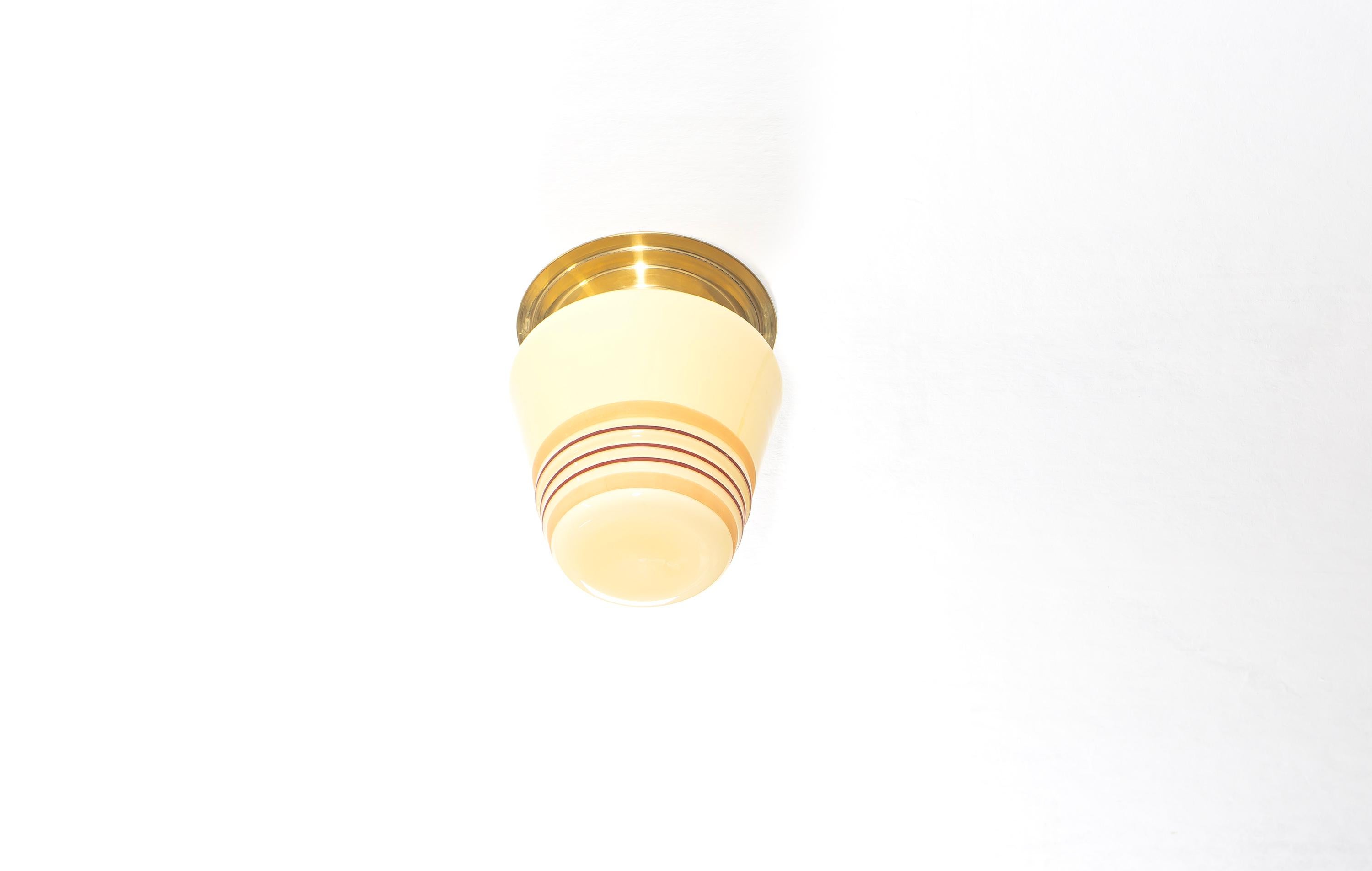 Sculptural ceiling light with hand-decorated shade and brass metal base. Designed and made in Norway from circa 1950s first half. The lamp is fully working and in good vintage condition. It is fitted with one E27 bulb holder (works in the US) and