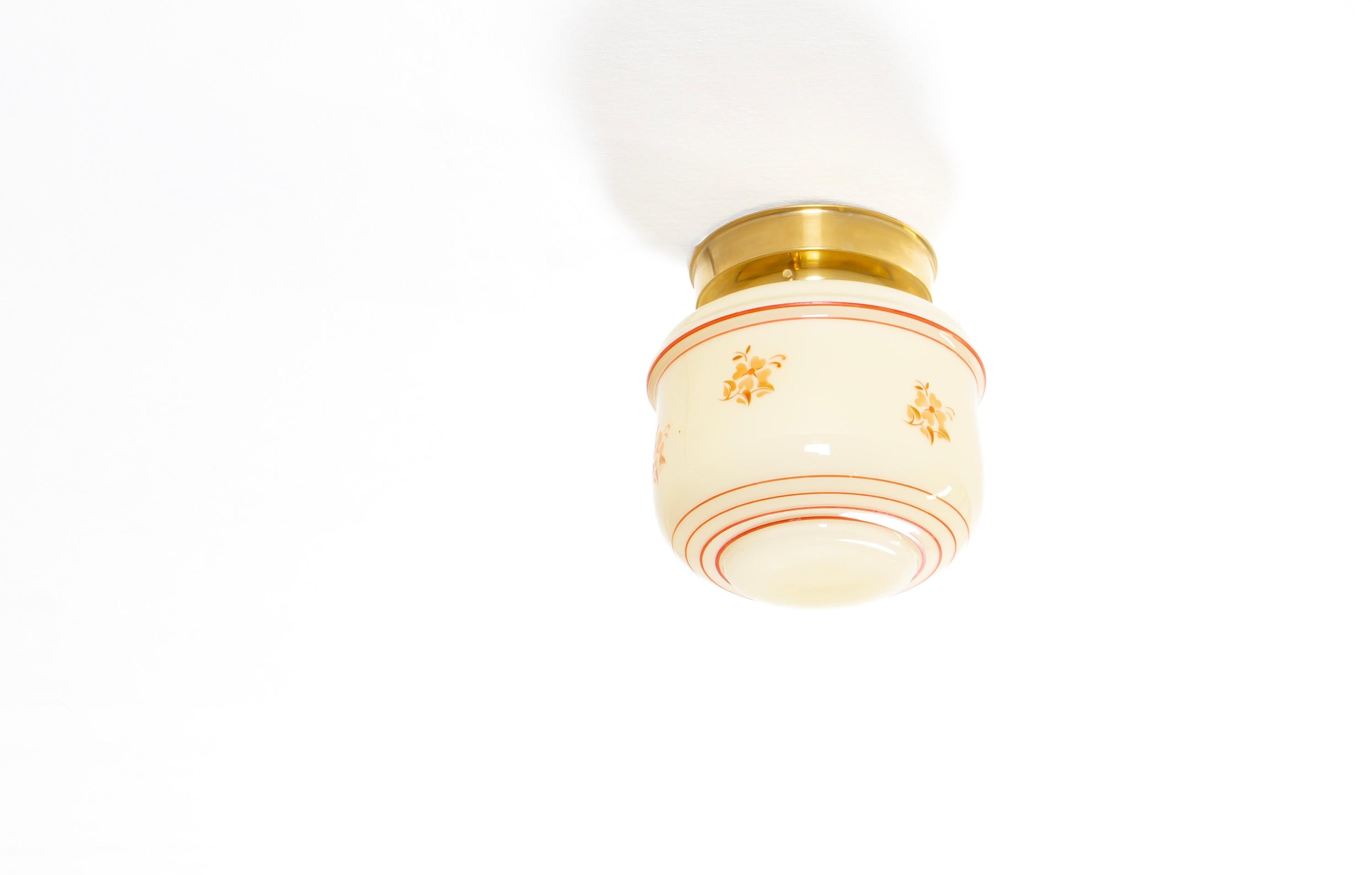 Decorative ceiling light with hand-decorated glass shade and brass metal base. Designed and made in Norway from circa 1950s first half. The lamp is fully working and in good vintage condition. It is fitted with one E27 bulb holder (works in the US)