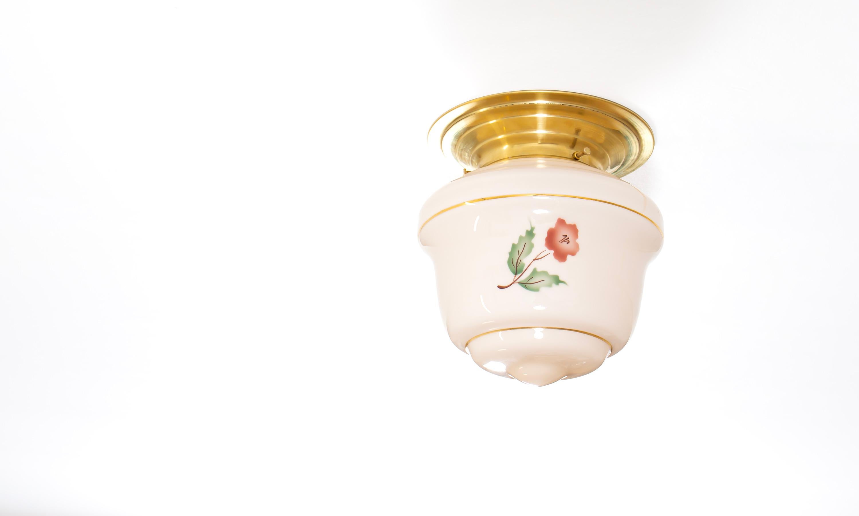 Wonderful ceiling light with hand-decorated glass shade and brass metal base. Designed and made in Norway from ca 1950s first half. The lamp is fully working and in good vintage condition. It is fitted with one E27 bulb holder (works in the US) and