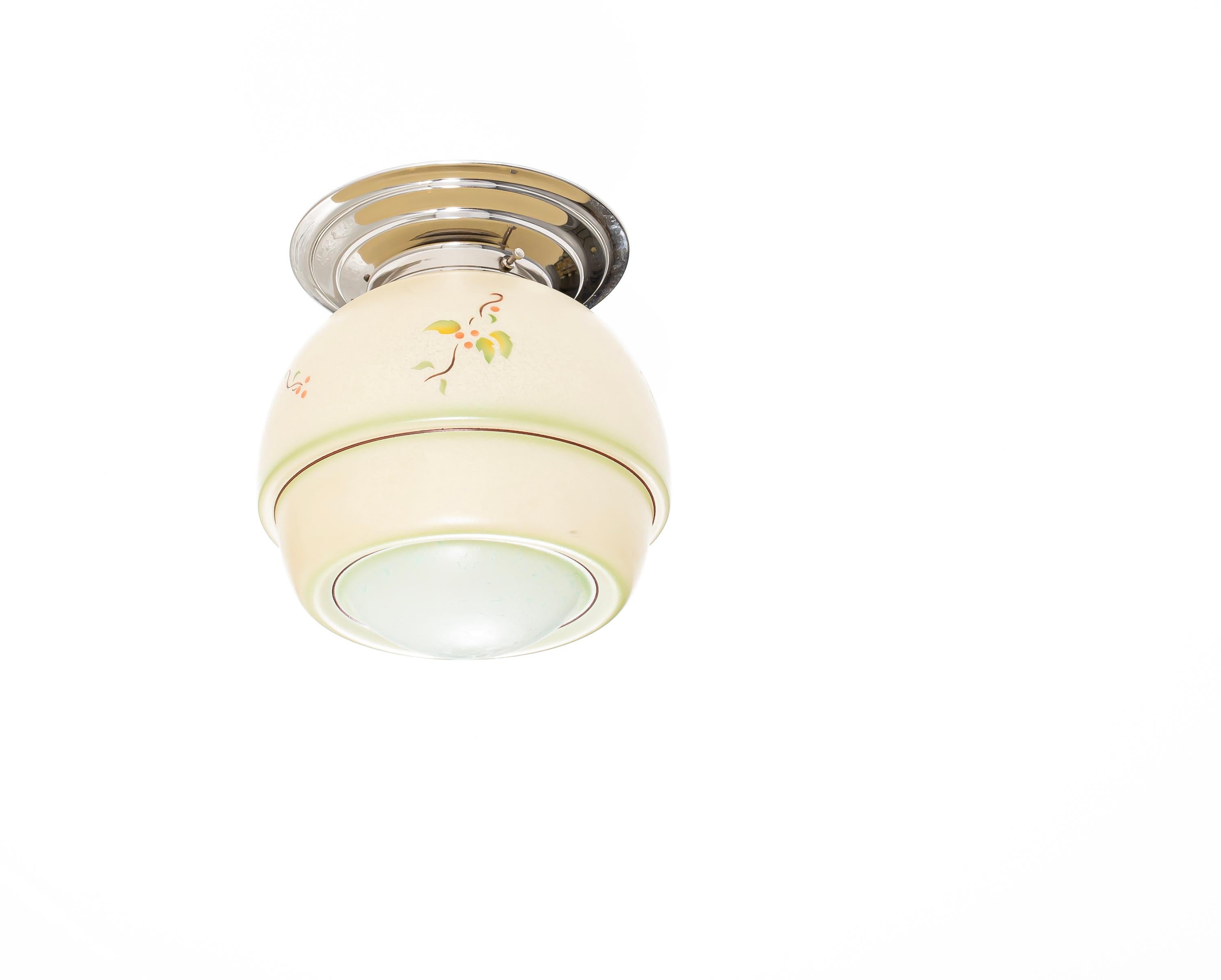 Decorative ceiling light with stenciled shade in glass and chrome metal base. Designed and made in Norway from ca 1950s first half. The lamp is fully working and in good vintage condition. It is fitted with one E27 bulb holder (works in the US) and