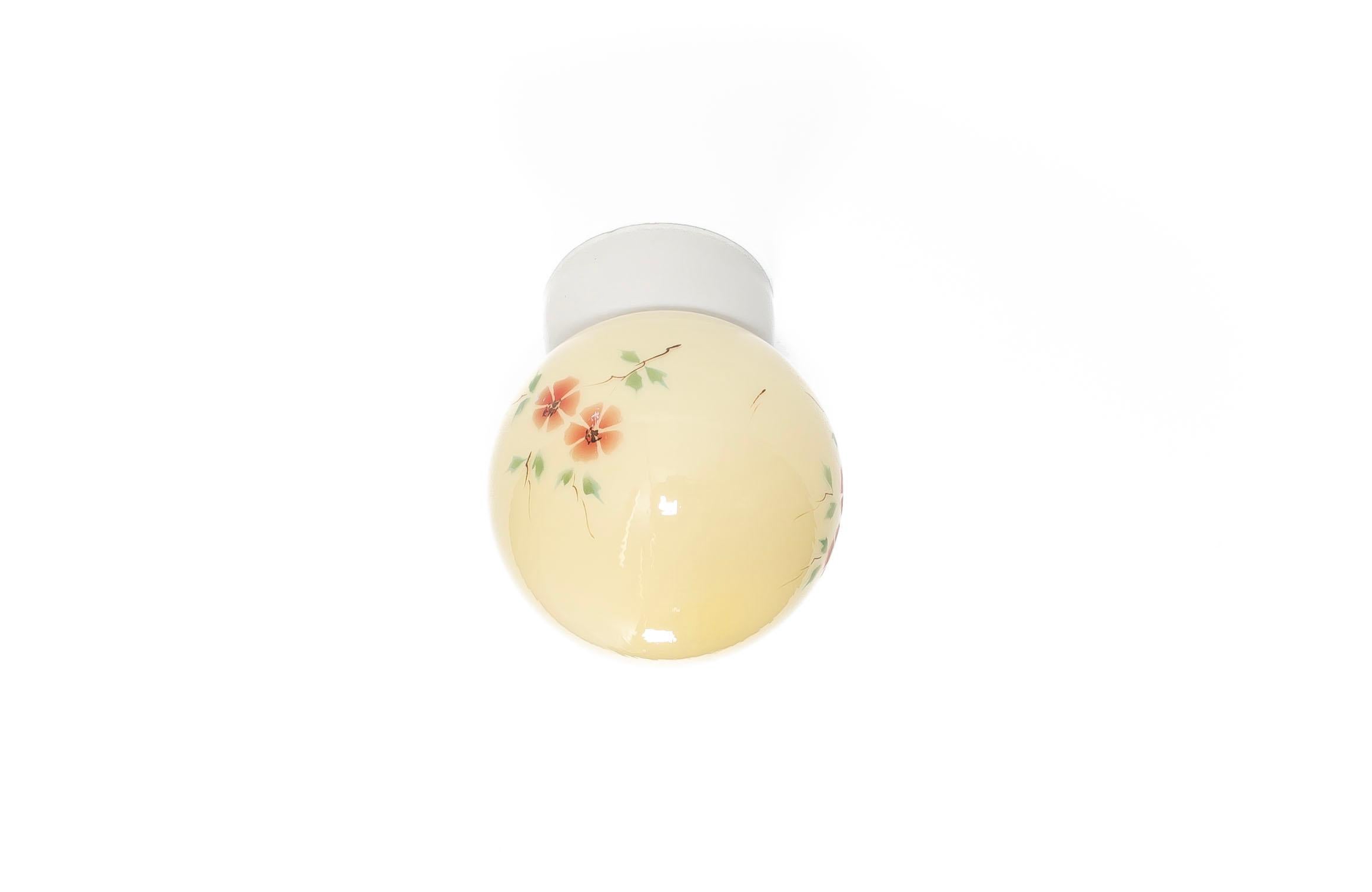 Wonderful and decorative ceiling light with shade in hand-painted glass and base in porcelain. Designed and made in Norway from circa 1950s first half. The lamp is fully working and in very good vintage condition. The lamp uses a E27 bulb (works in