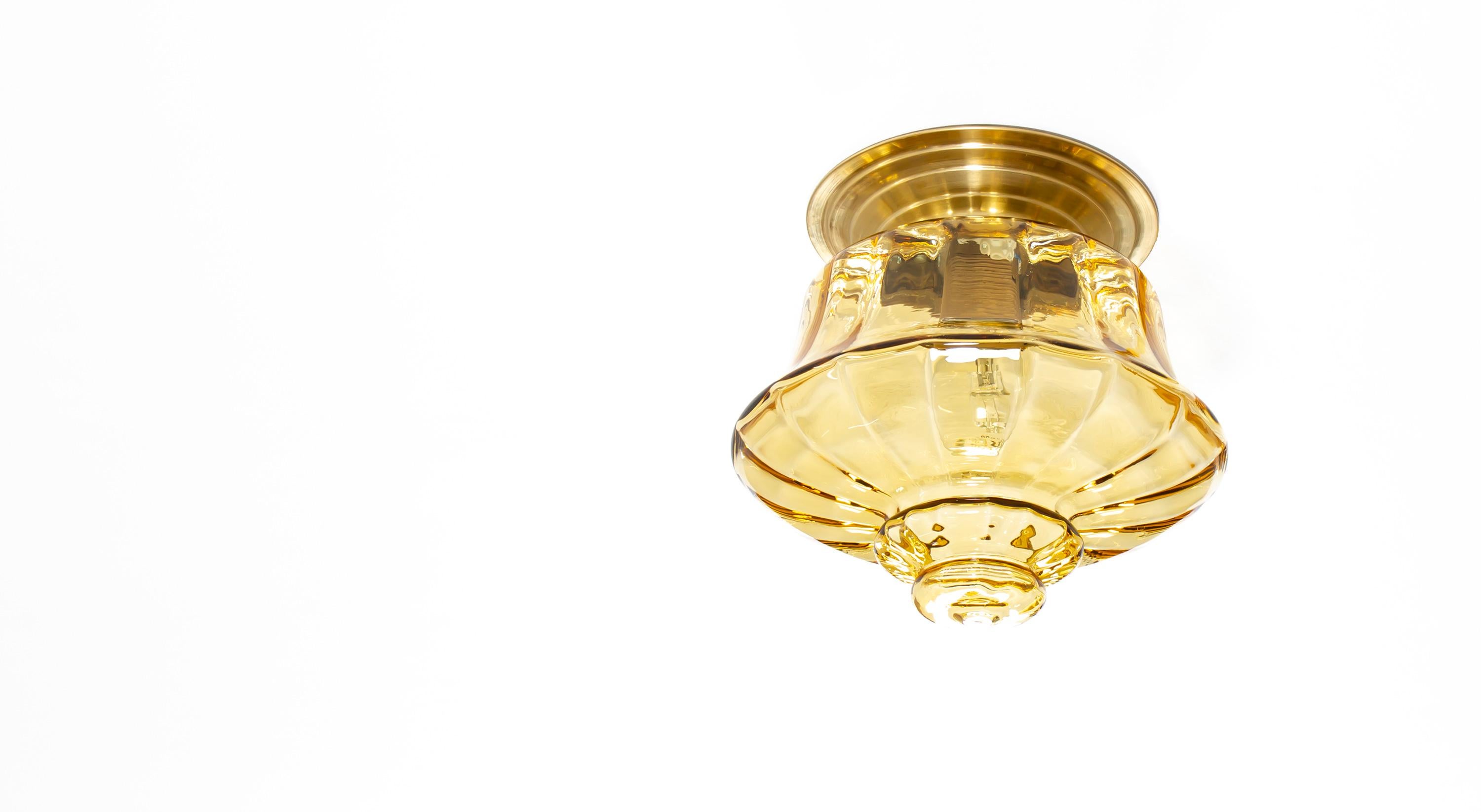 Decorative flush mount ceiling lamp in blown glass with a base in brass. Designed and made in Norway from circa 1970s first half. The lamp is fully working and in good vintage condition. The lamp is fitted with one E27 bulb holder (works in the US)