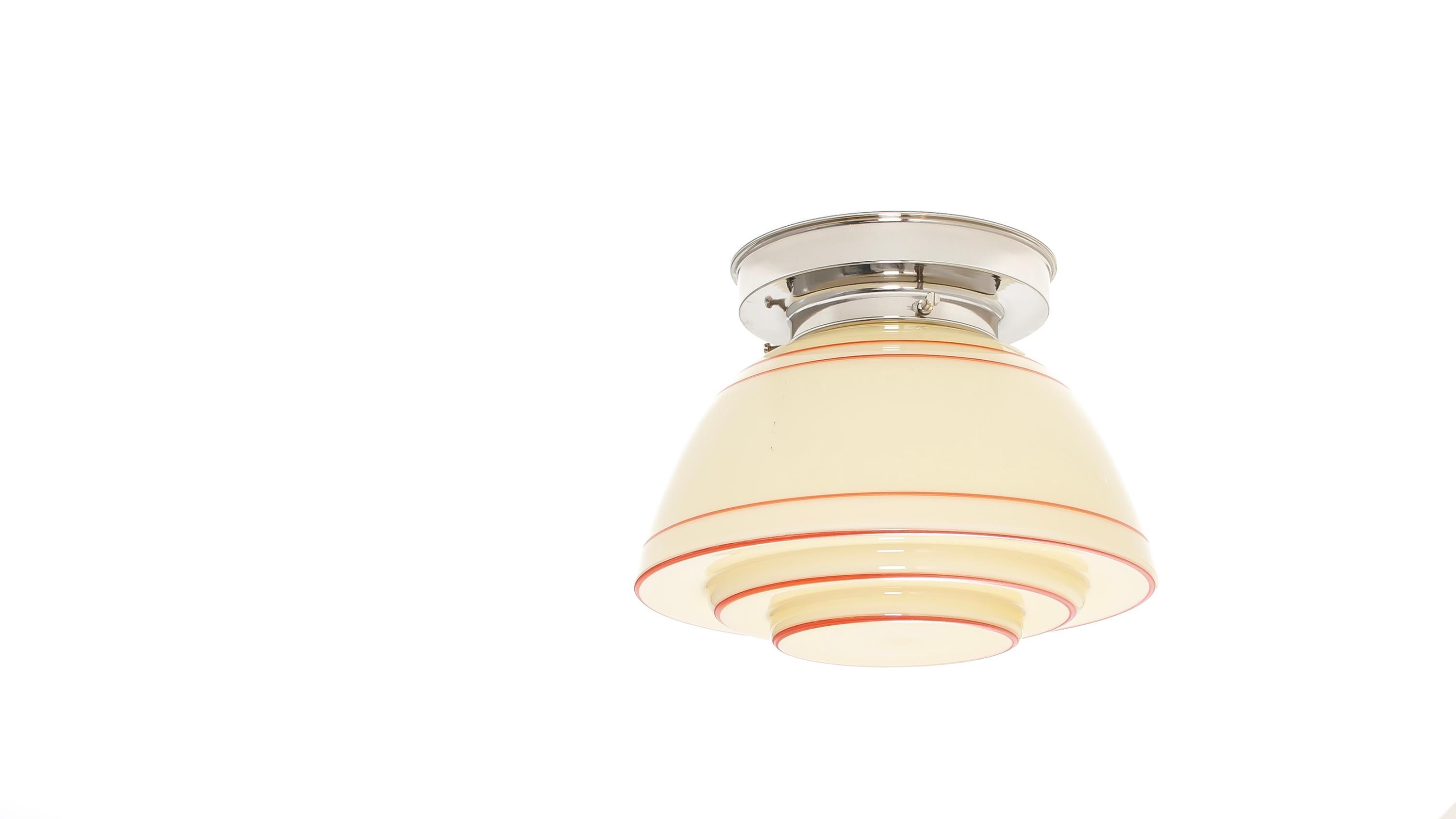Wonderful and decorative ceiling light in opaline glass with chrome metal base. Designed and made in Norway from ca 1950s first half. The lamp is fully working and in good vintage condition. It is fitted with one E27 bulb holder (works in the US)