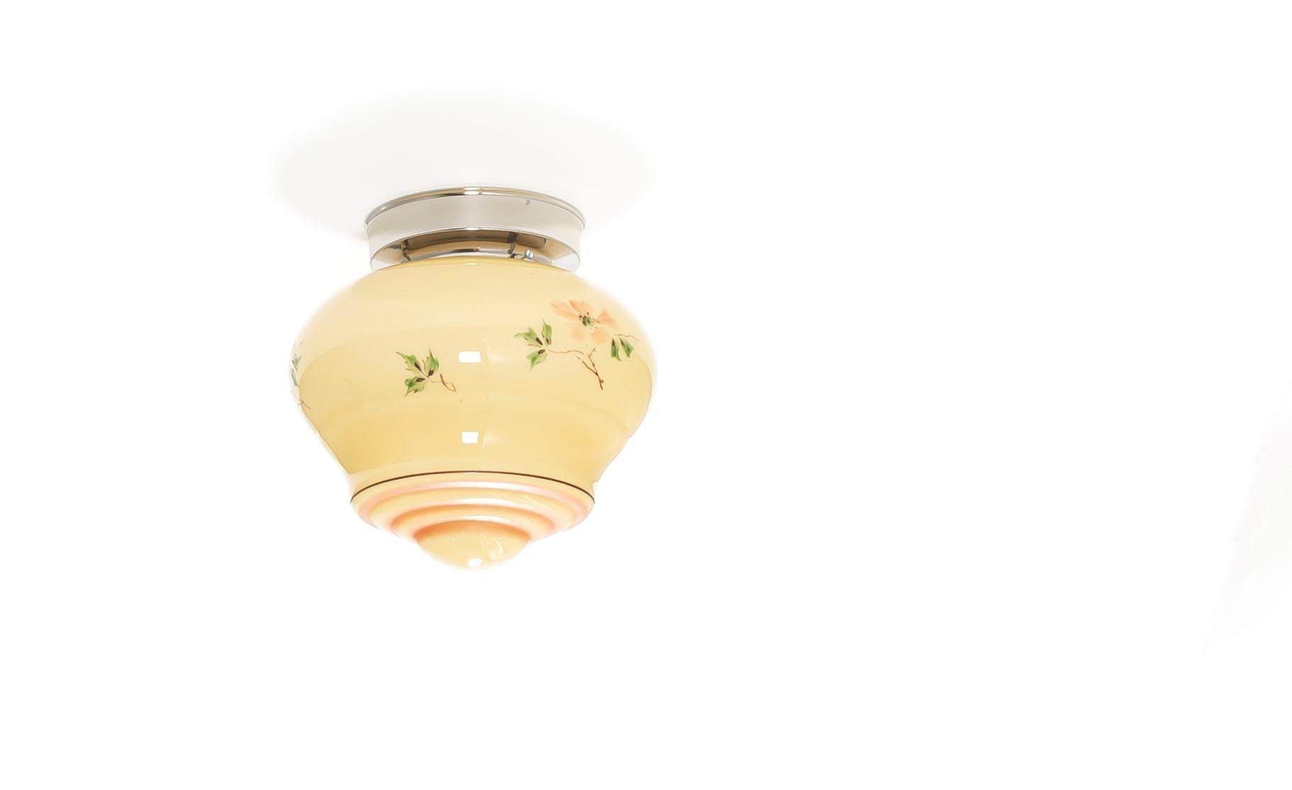 Wonderful and decorative ceiling light in opaline glass with chrome metal base. Designed and made in Norway from ca 1950s first half. The lamp is fully working and in good vintage condition. It is fitted with one E27 bulb holder (works in the US)