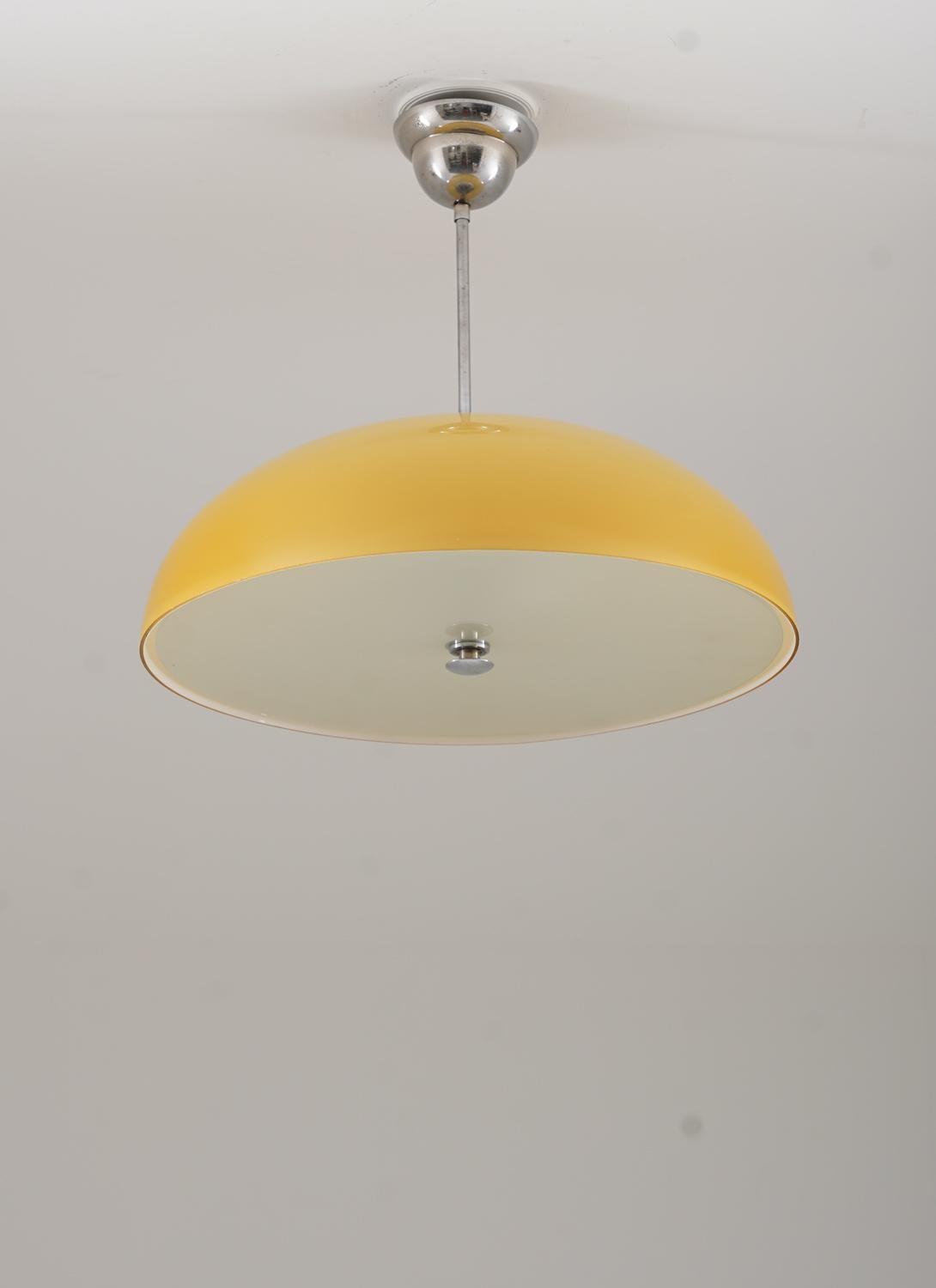 Beautiful pendant in chrome and glass, produced in Sweden circa 1930.
The lamp consists of an amber-colored shade and a frosted glass diffuser. 

Condition: Very good original condition. 

Wiring: All our lamps are wired for EU standards.