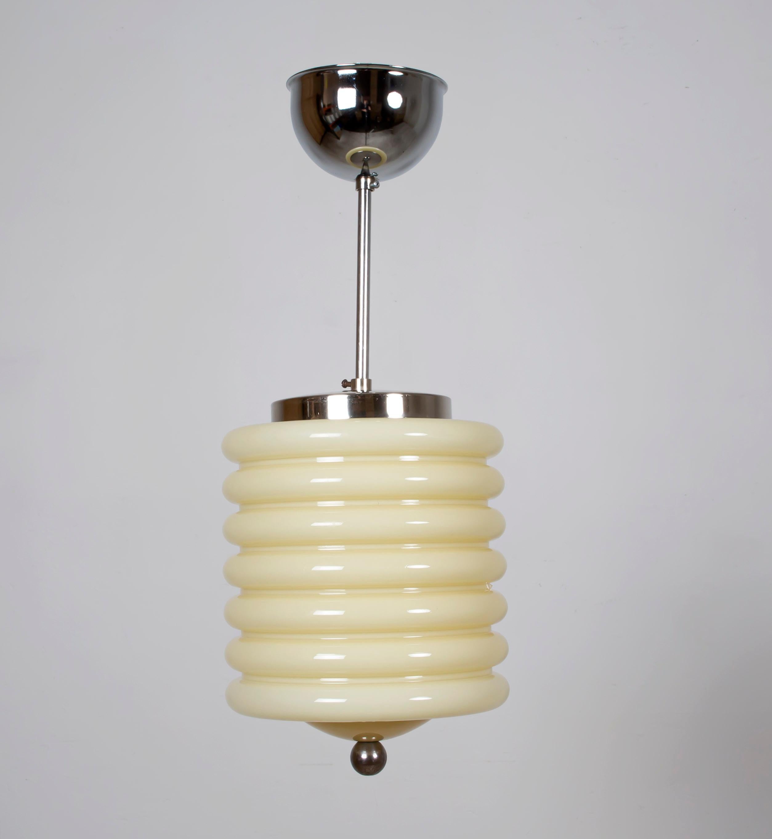 Wonderful and decorative ceiling lamp in steel, with shade in opaline glass. Designed and made in Norway by Høvik Lys from circa 1950s first half. The lamp is fully working and in very good vintage condition. The chrome stem has been cleaned and