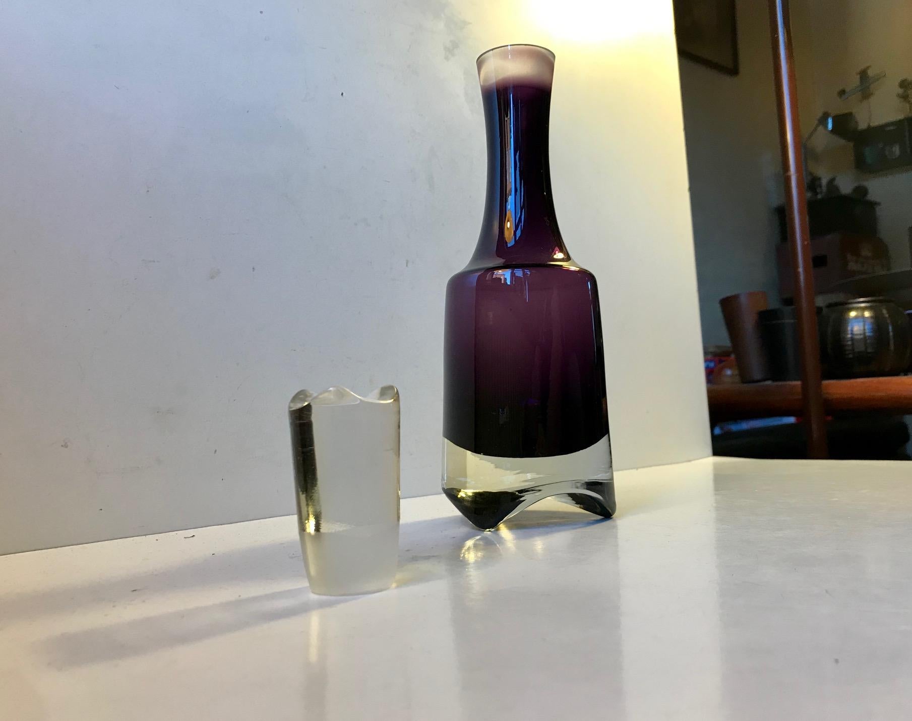 A modernist/Brutalist styled decanter for Gin or Vodka. It’s made from amethyst summerso glass. Notice that the tristand formation to the bottom matches the shape of the stopper. It’s manufactured in Scandinavia during the 1970s probably by either