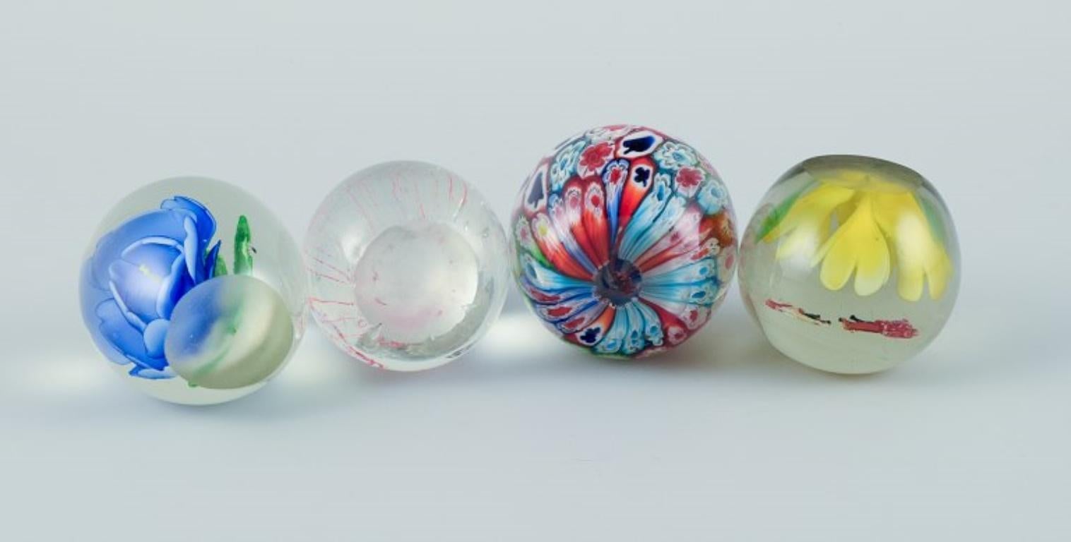 Scandinavian glass artist. Four paperweights in art glass. Flower motifs. For Sale 1