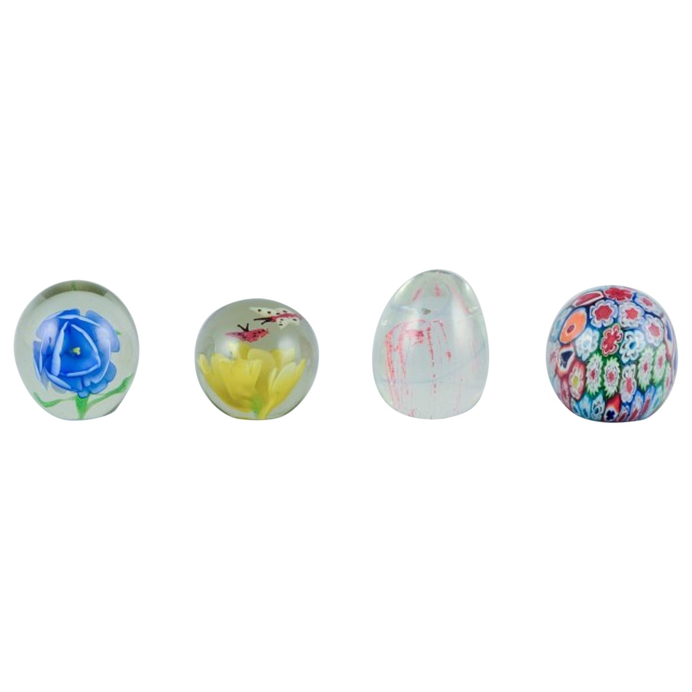 Scandinavian glass artist. Four paperweights in art glass. Flower motifs.