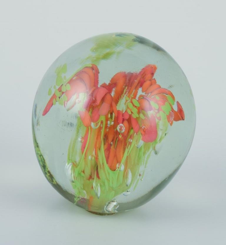 Late 20th Century Scandinavian glass artist. Three paperweights in art glass. Flower motifs. For Sale