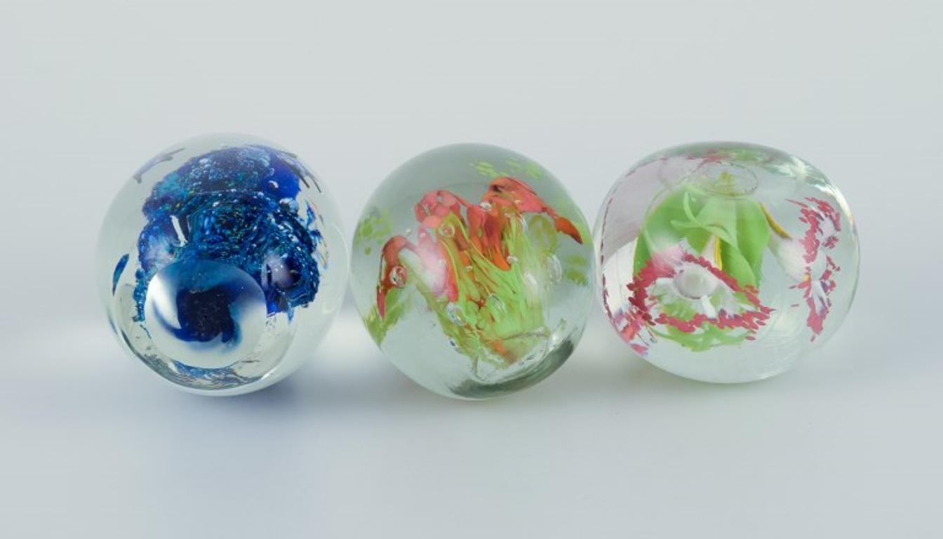 Scandinavian glass artist. Three paperweights in art glass. Flower motifs. For Sale 2